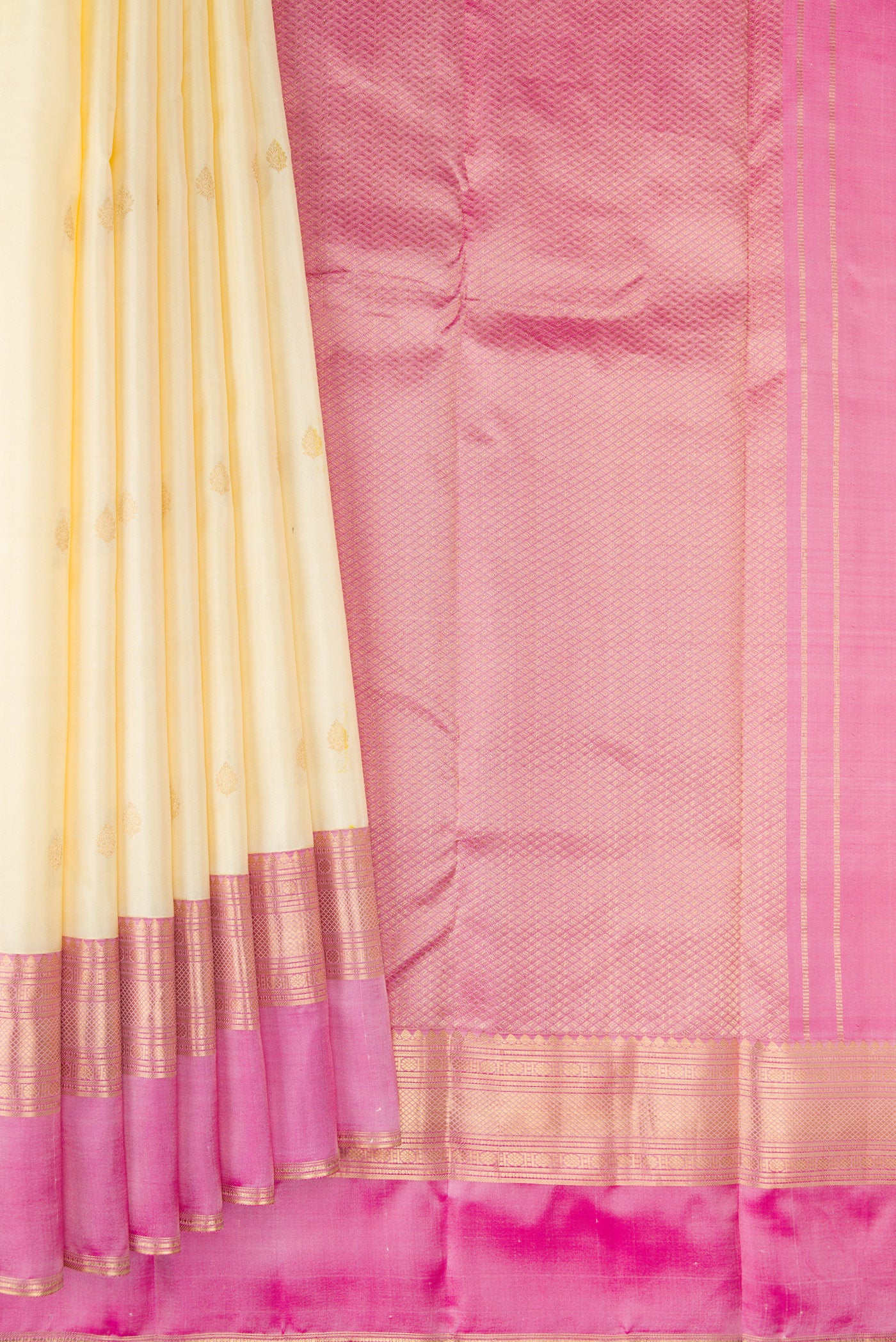 Pleats and pallu of Cream Kanchipuram Silk Saree with Zari Butta on the body and Ganga Jamuna Border. 