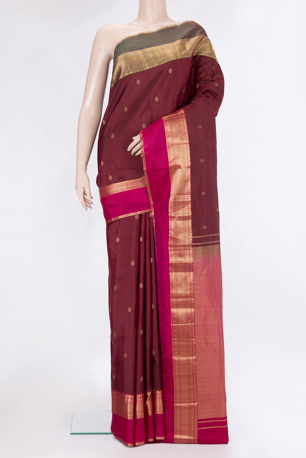 Maroon Kanchipuram Silk Saree with Zari Butta on the body and Ganga Jamuna Border.  displayed on a mannequin