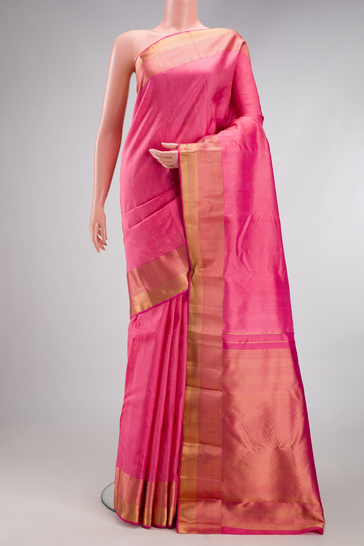 Pink Kanchipuram Silk Saree with Zari Butta on the body and Zari Border.  displayed on a mannequin