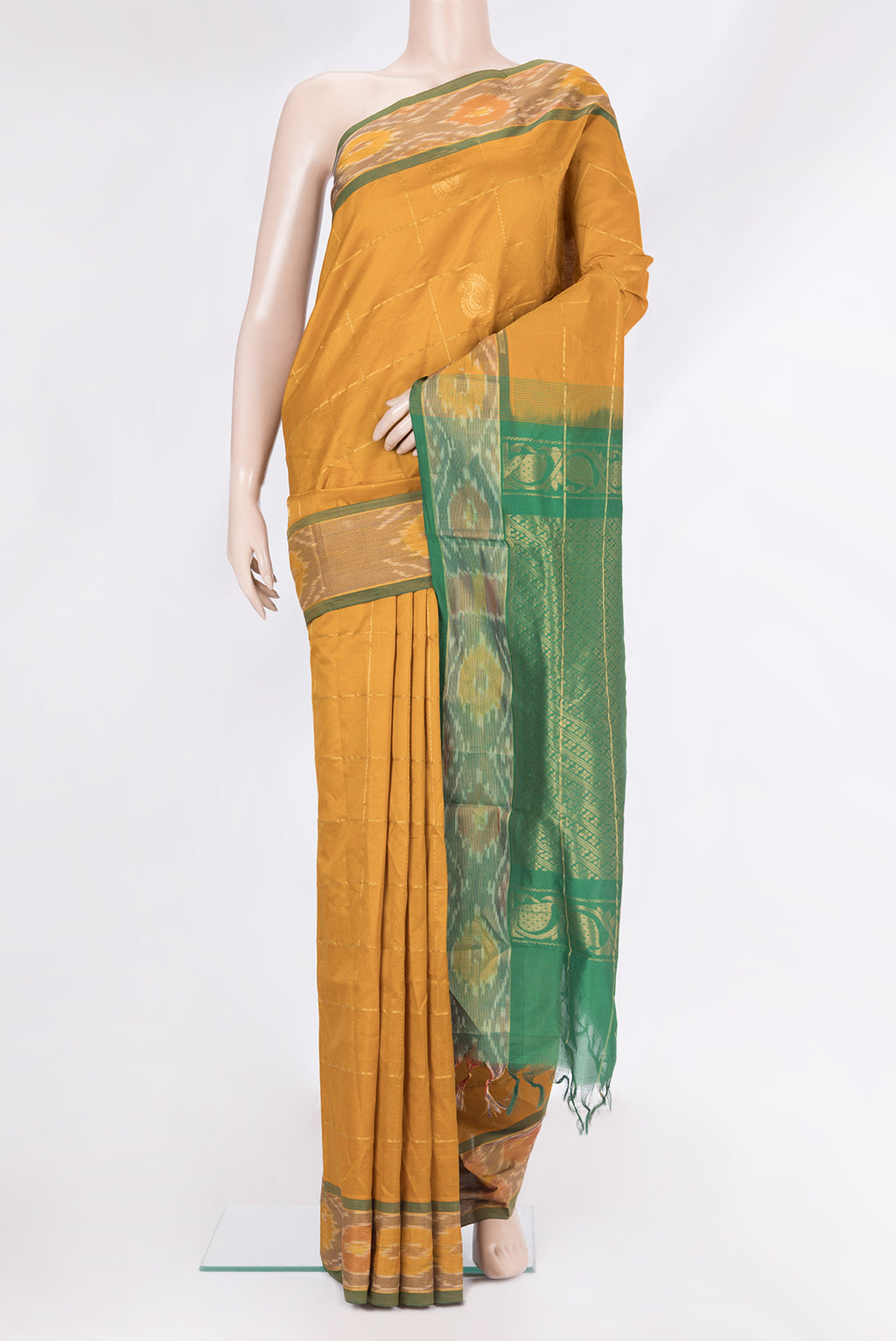 Mustard Silk Cotton Saree with Checked design on the body and Ikat Border.  displayed on a mannequin