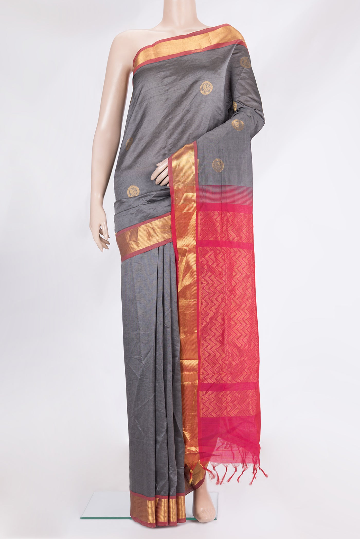 Grey Silk Cotton Saree with Zari Butta on the body and Zari Border.  displayed on a mannequin