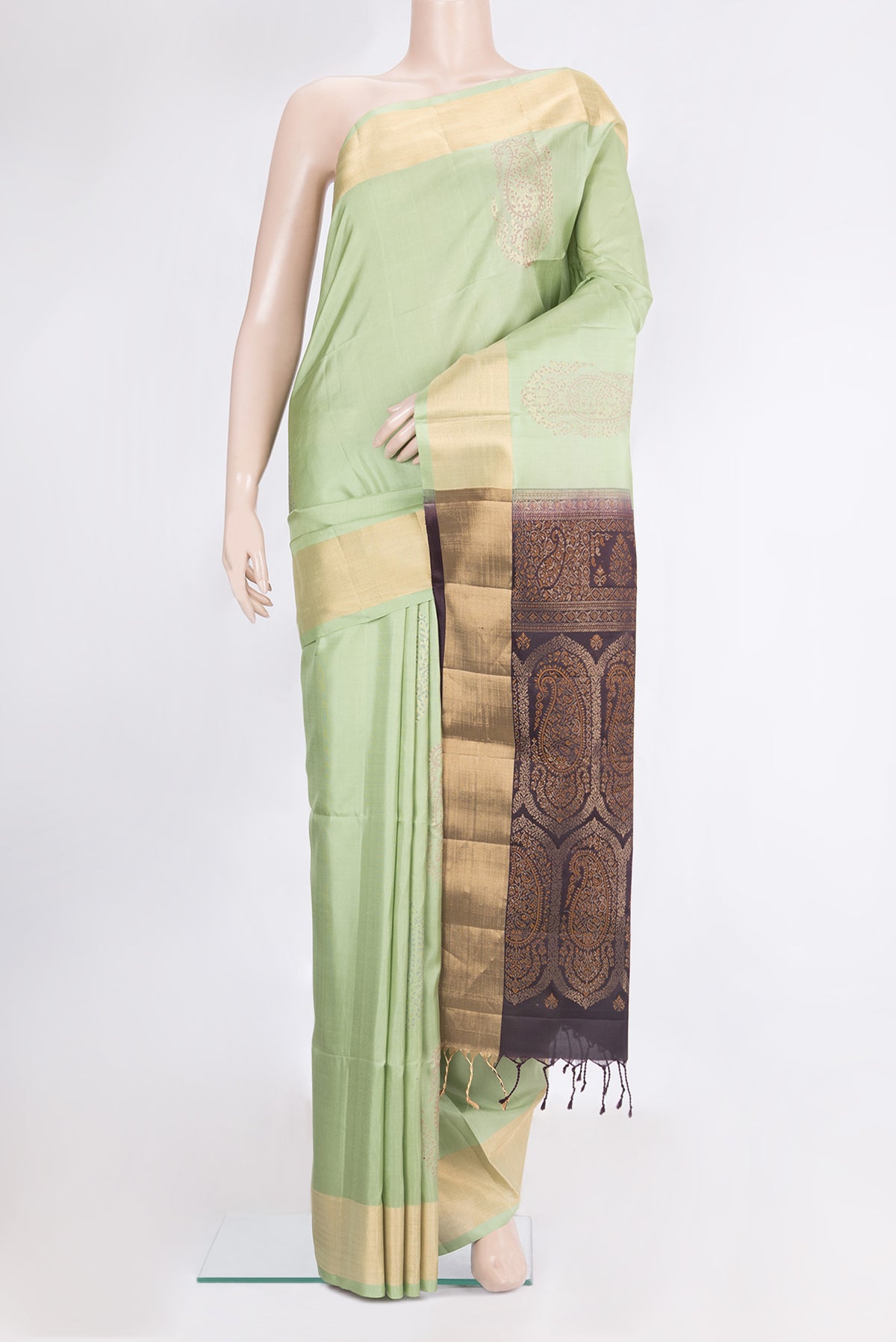 Pure Silk Pista Green Soft Saree with Zari Butta on the body and Zari Border.  displayed on a mannequin