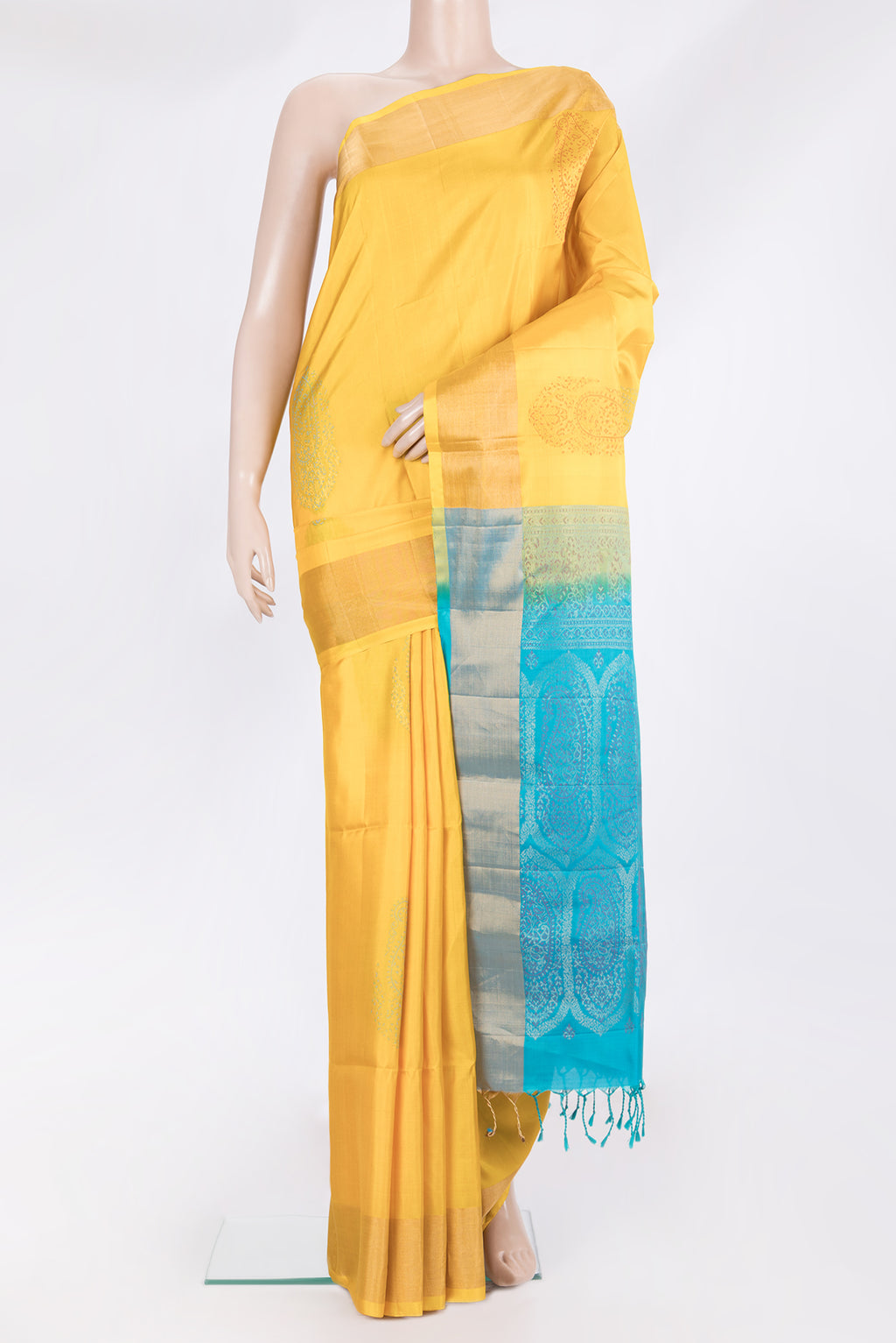 Pure Silk Yellow Soft Saree with Zari And Thread Butta on the body and Zari Border.  displayed on a mannequin