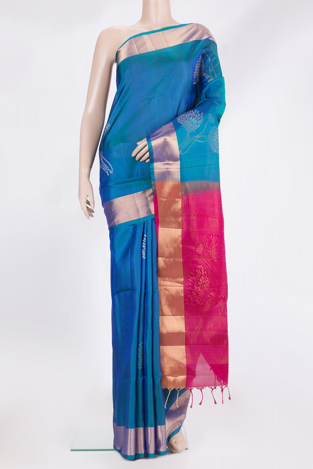 Pure Silk Peacock Blue Soft Saree with Zari Butta on the body and Zari Border.  displayed on a mannequin