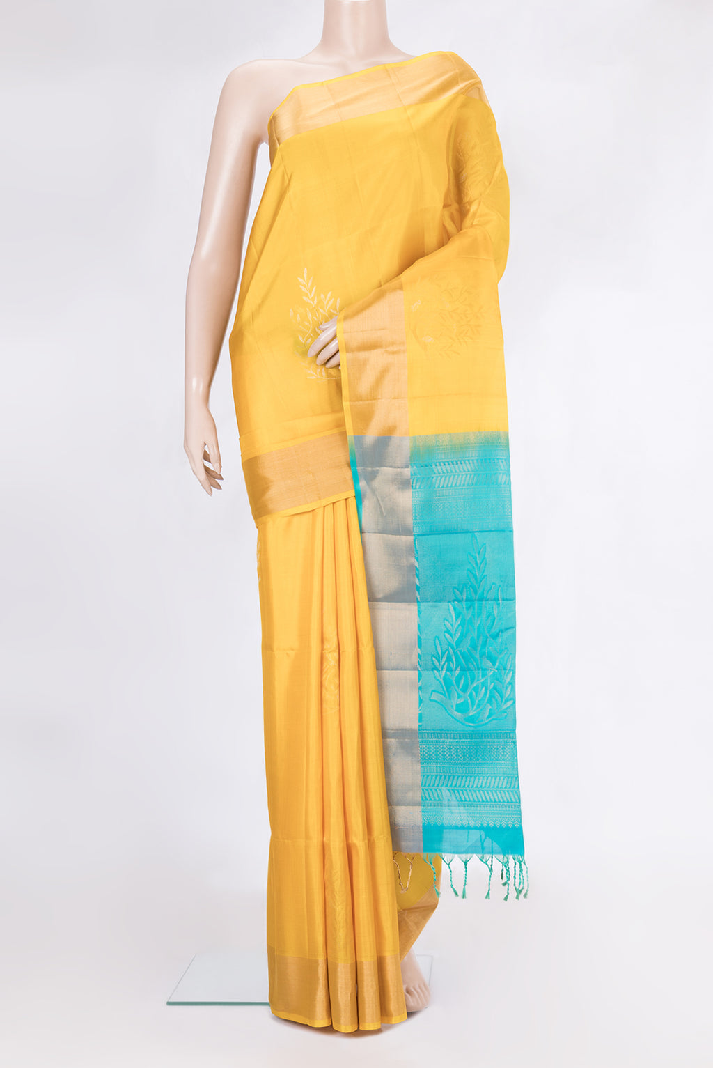 Yellow Soft Silk Saree with Zari Butta on the body and Zari Border.  displayed on a mannequin