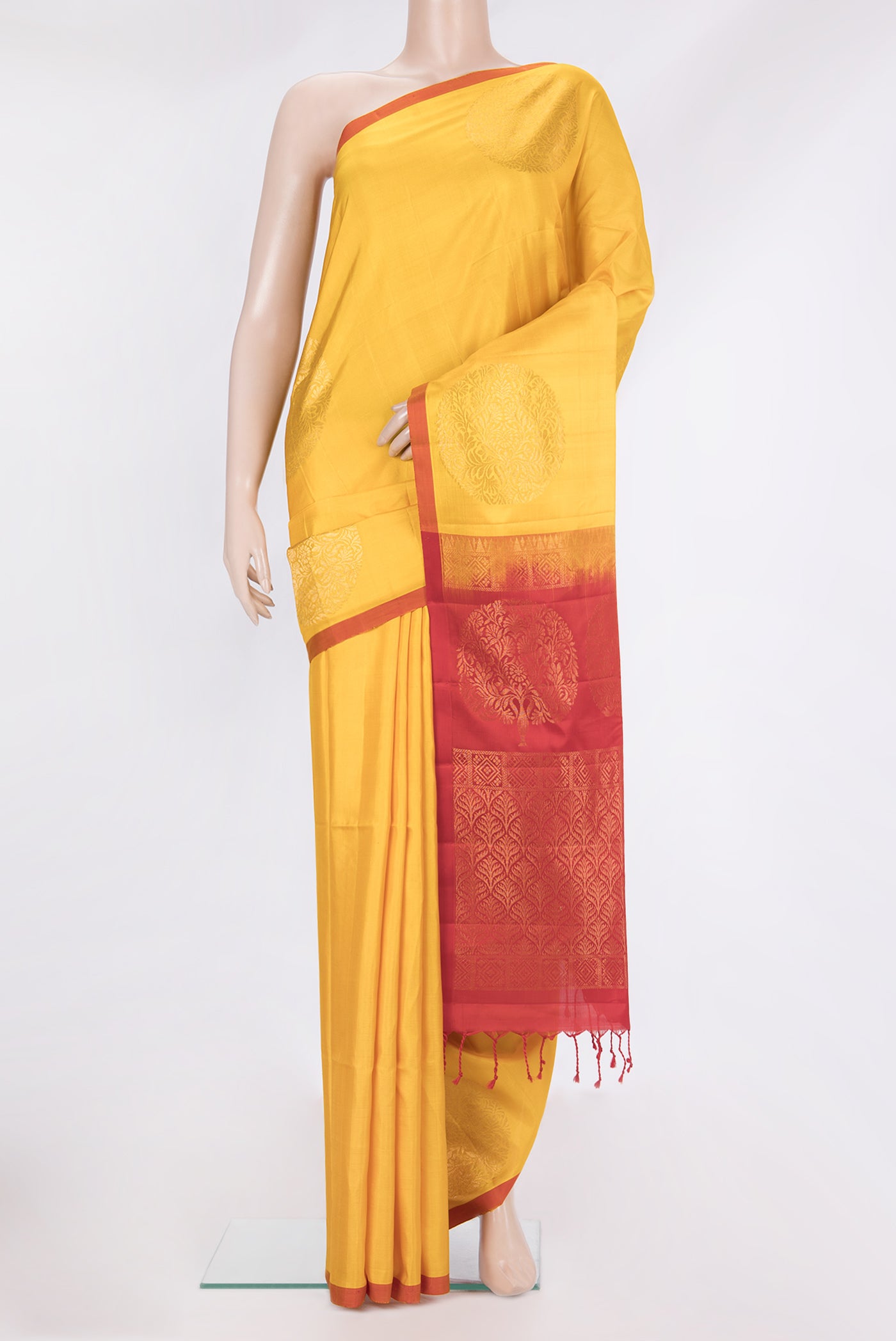 Pure Silk Yellow Soft Saree with Zari Butta on the body and Plain Border.  displayed on a mannequin