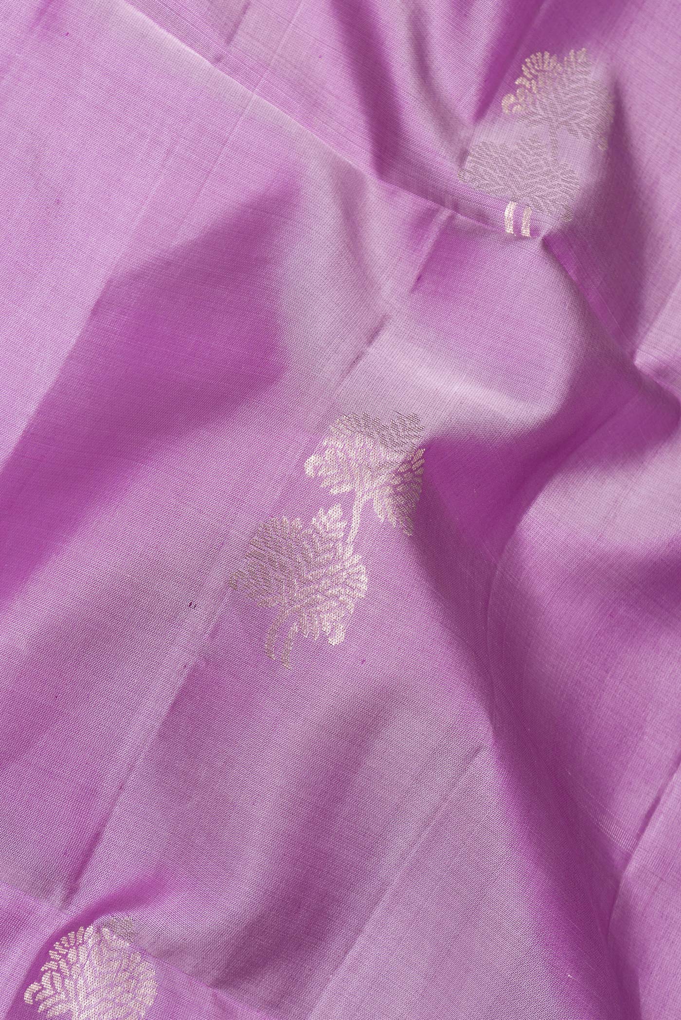 Close up of Pure Silk Lavender Soft Saree with Zari Butta on the body and Zari Border.  displaying folds
