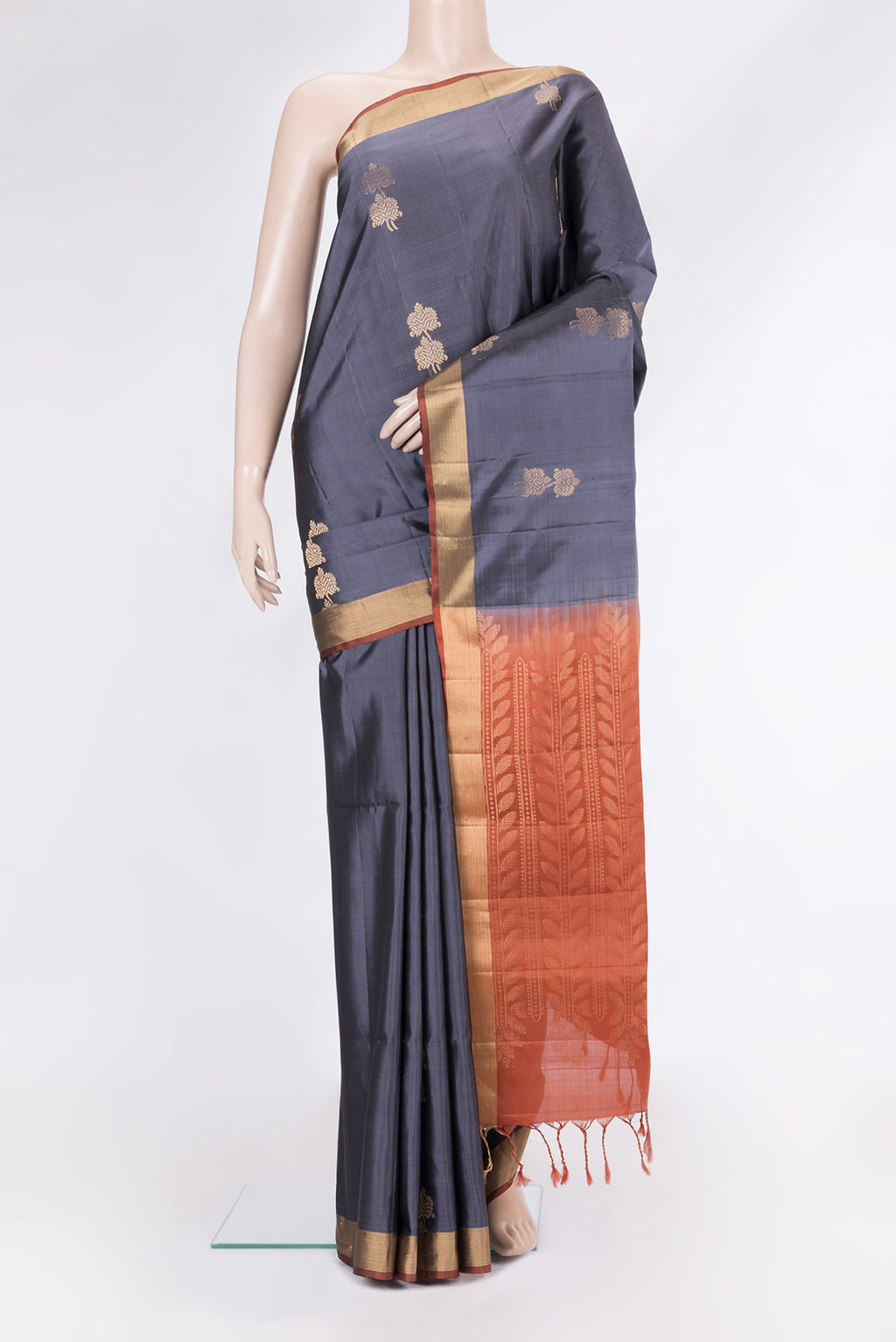 Grey Soft Silk Saree with Zari Butta on the body and Zari Border.  displayed on a mannequin