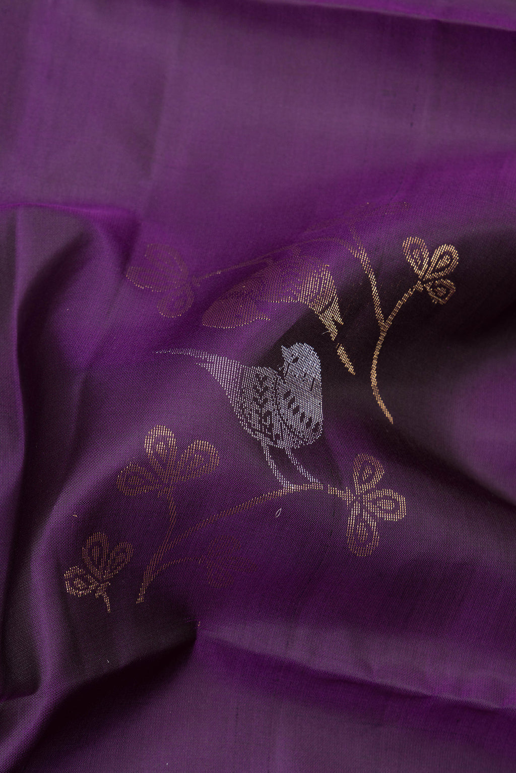 Close up of Pure Silk Purple Soft Saree with Zari Butta on the body and Zari Border.  displaying folds