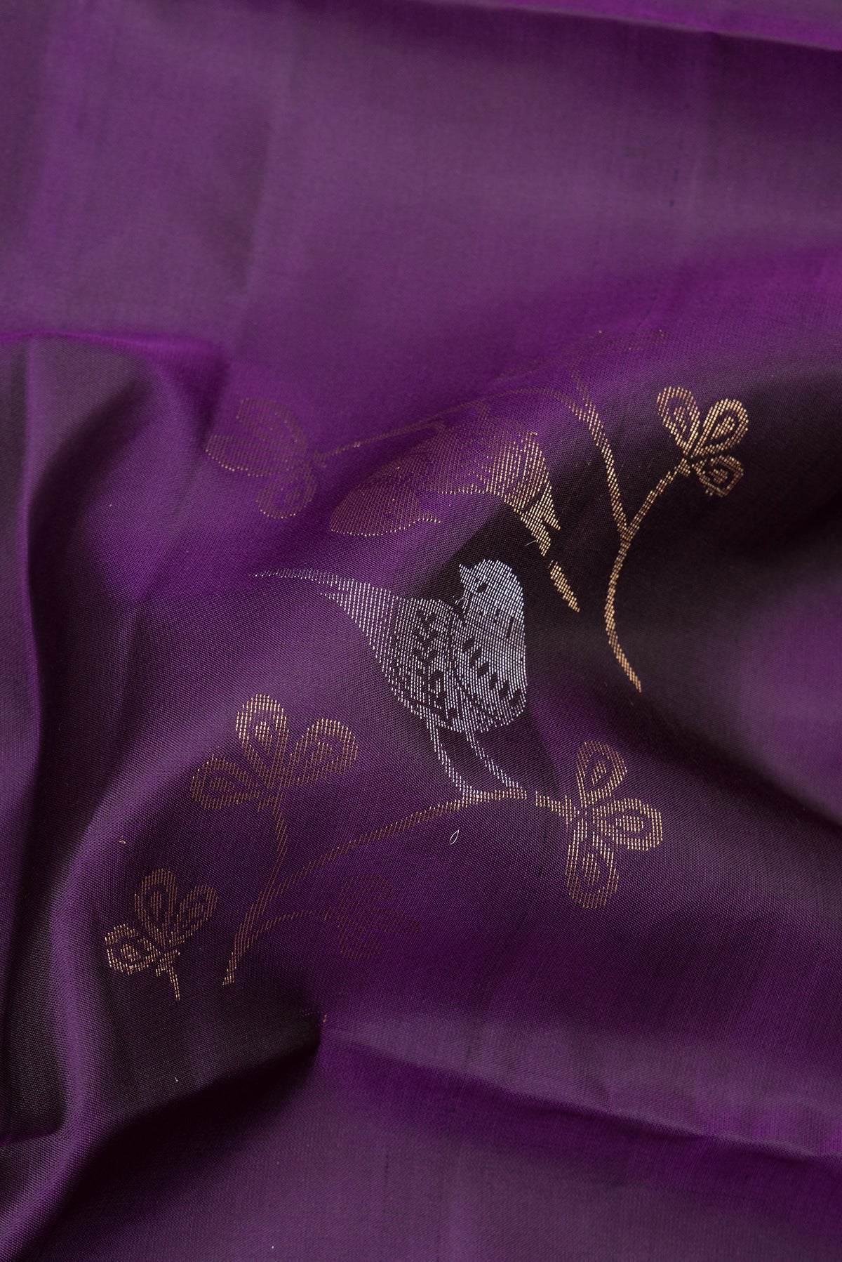 Close up of Pure Silk Purple Soft Saree with Zari Butta on the body and Zari Border.  displaying folds