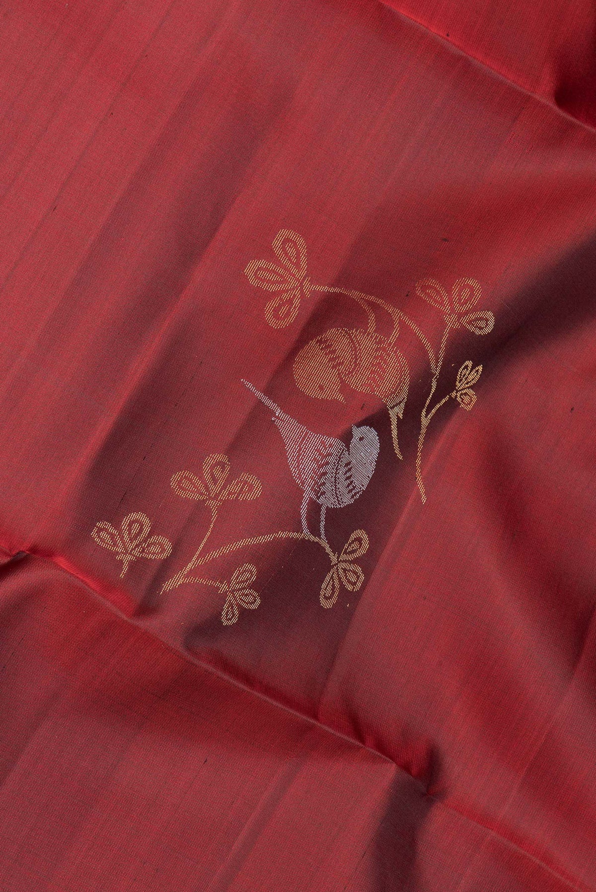 Close up of Pure Silk Maroon Soft Saree with Zari Butta on the body and Zari Border.  displaying folds