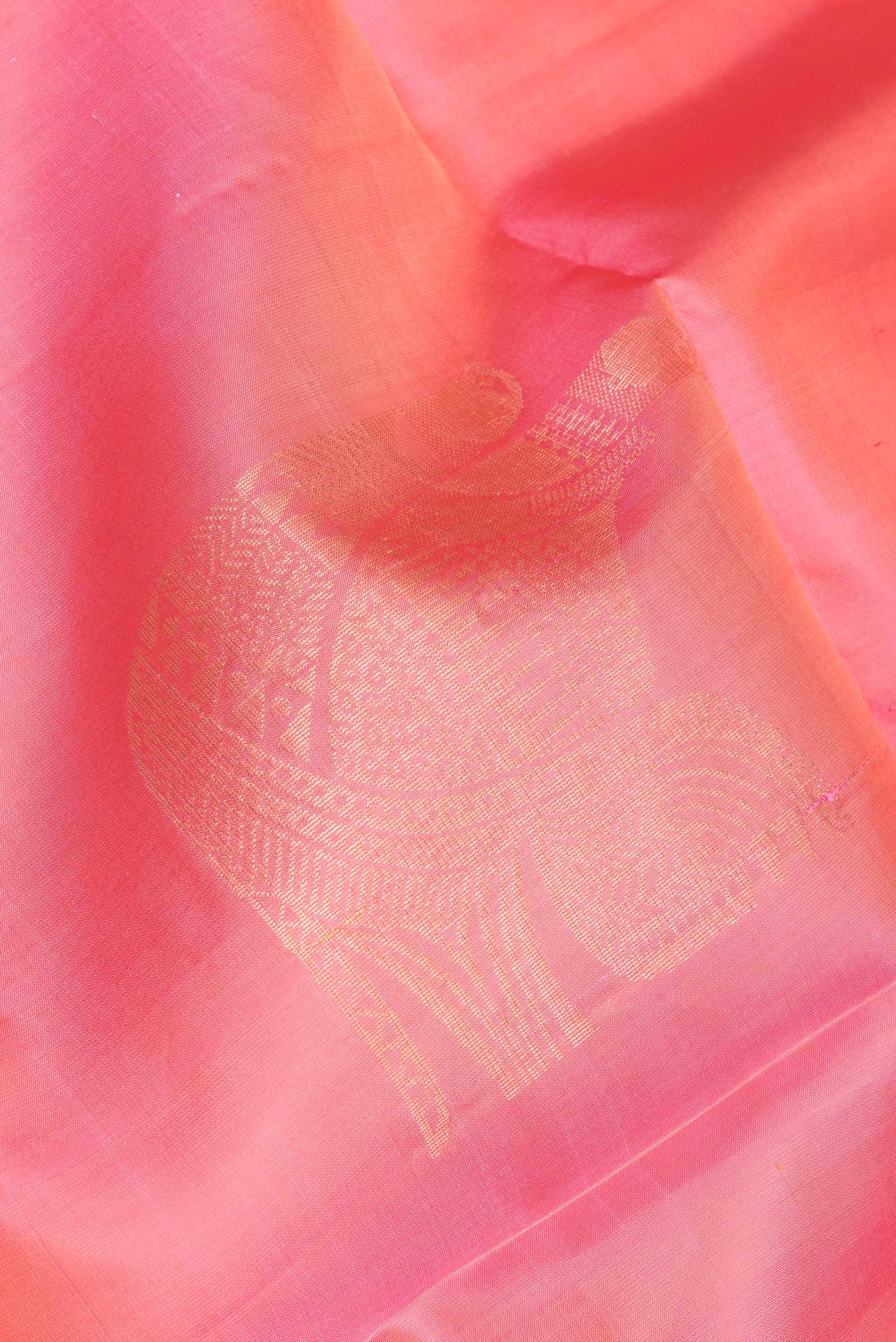 Close up of Pink Soft Silk Saree with Zari Butta on the body and Zari Border.  displaying folds