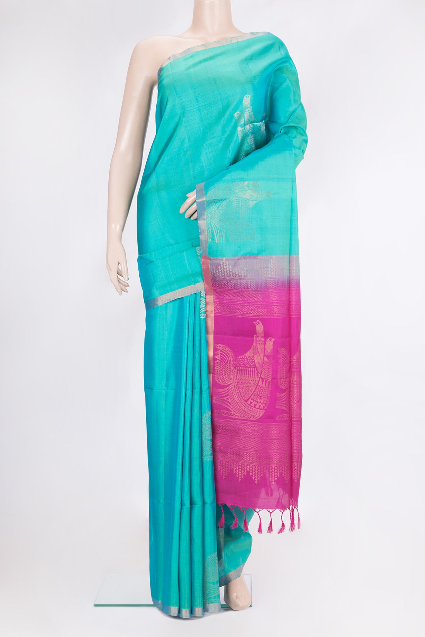 Pure Silk Turquoise Soft Saree with Zari Butta on the body and Zari Border.  displayed on a mannequin