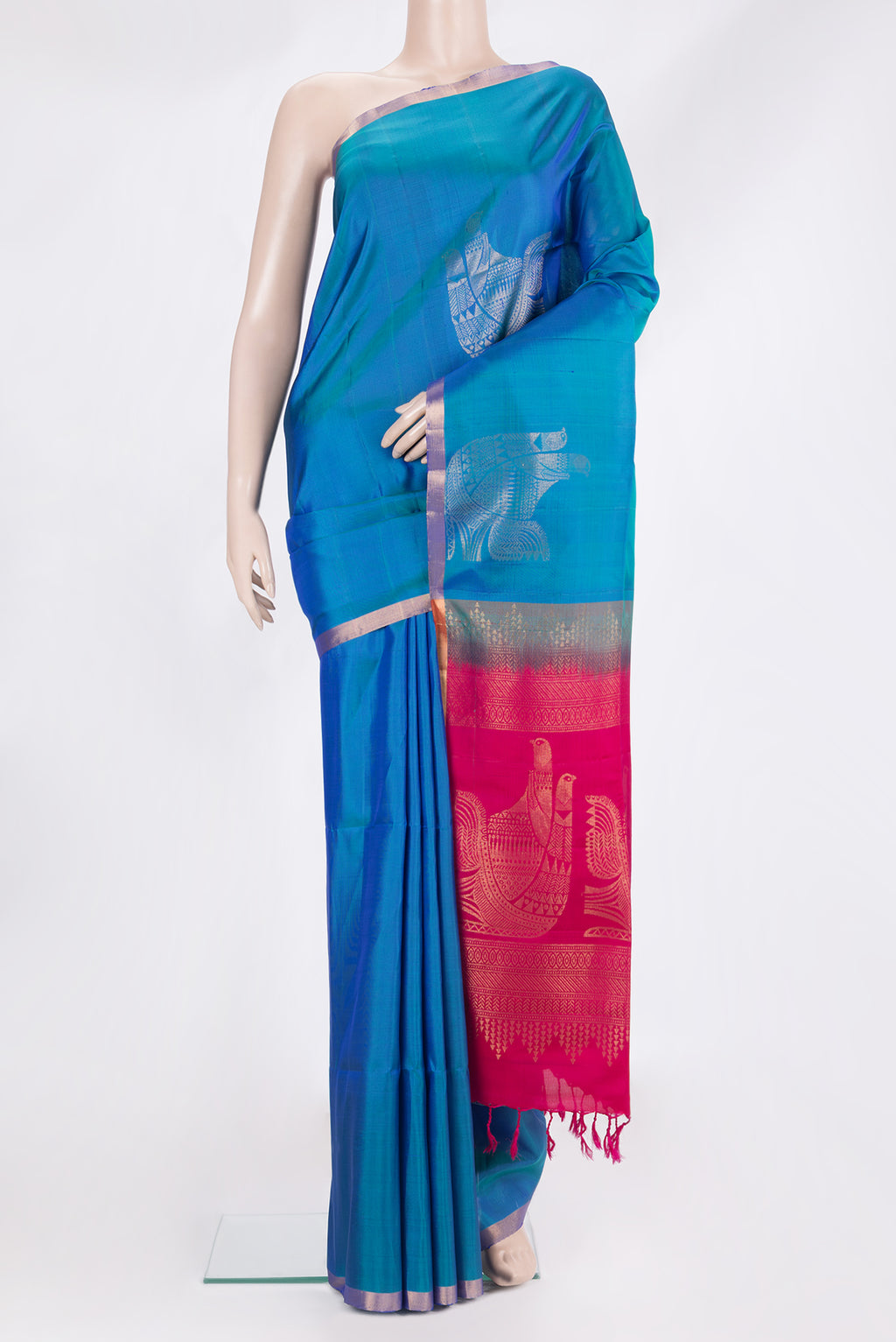 Pure Silk Peacock Blue Soft Saree with Zari Butta on the body and Zari Border.  displayed on a mannequin