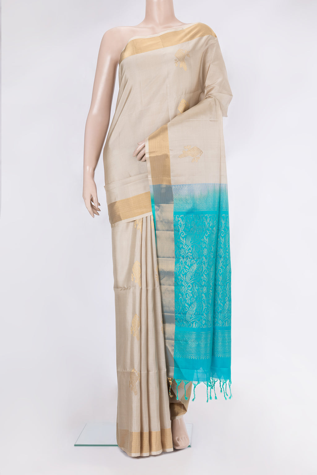 Beige Soft Silk Saree with Zari Butta on the body and Zari Border.  displayed on a mannequin