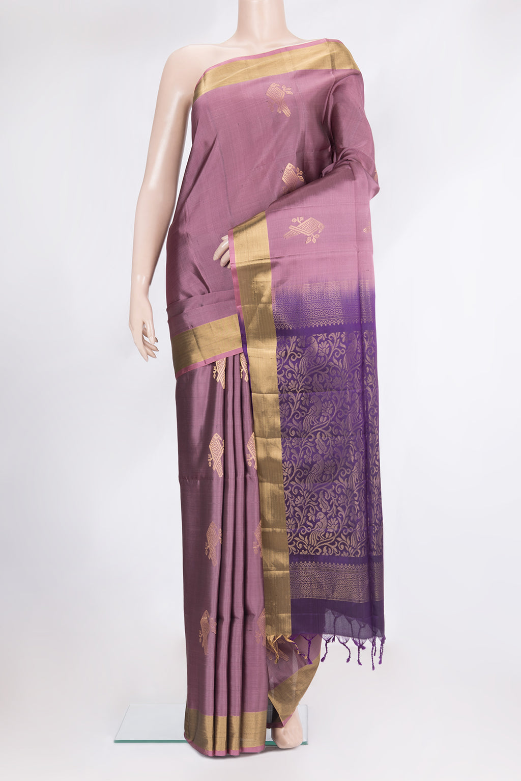 Pure Silk Mauve Soft Saree with Zari Butta on the body and Zari Border.  displayed on a mannequin