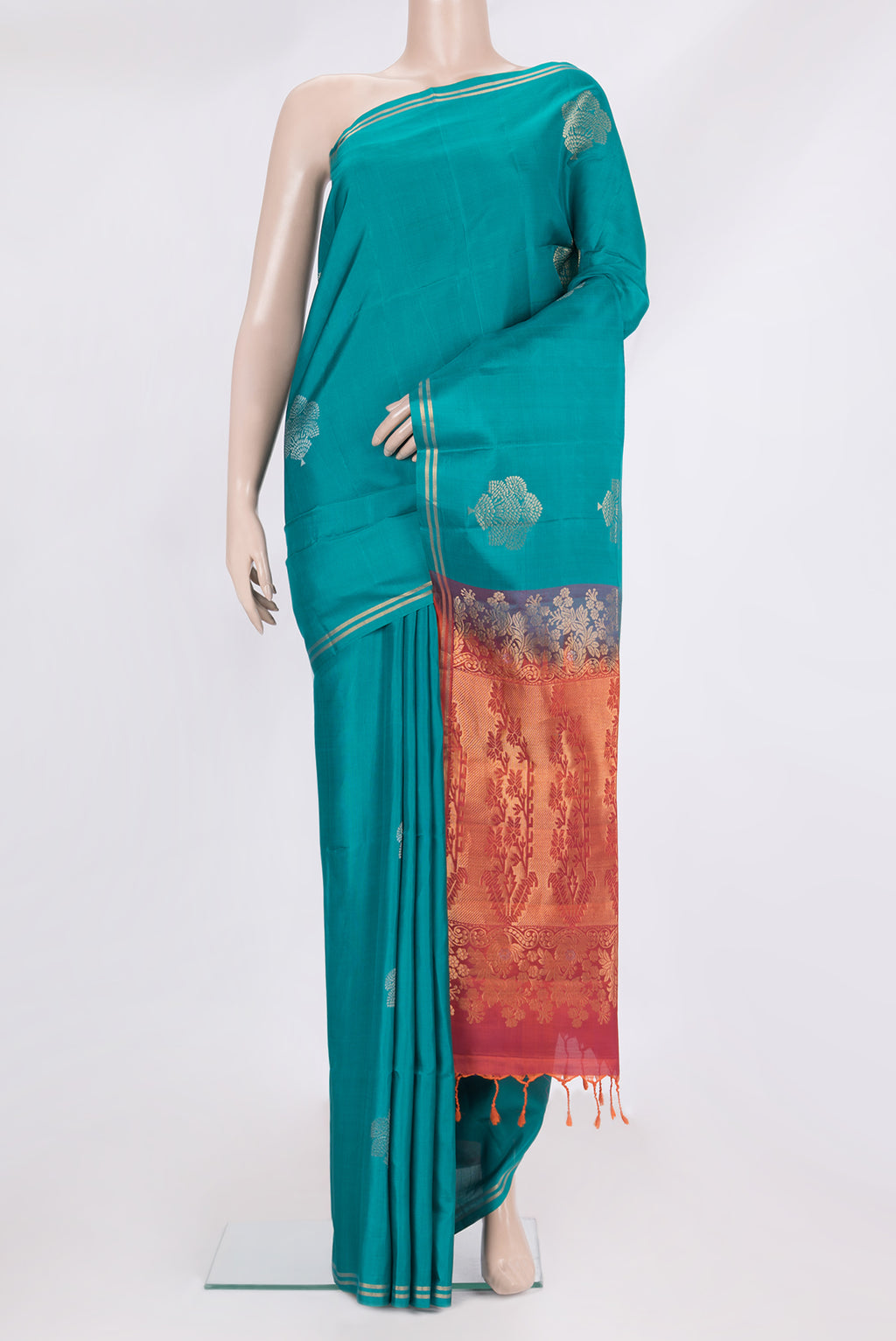 Pure Silk Peacock Blue Soft Saree with Zari Butta on the body and Zari Border.  displayed on a mannequin