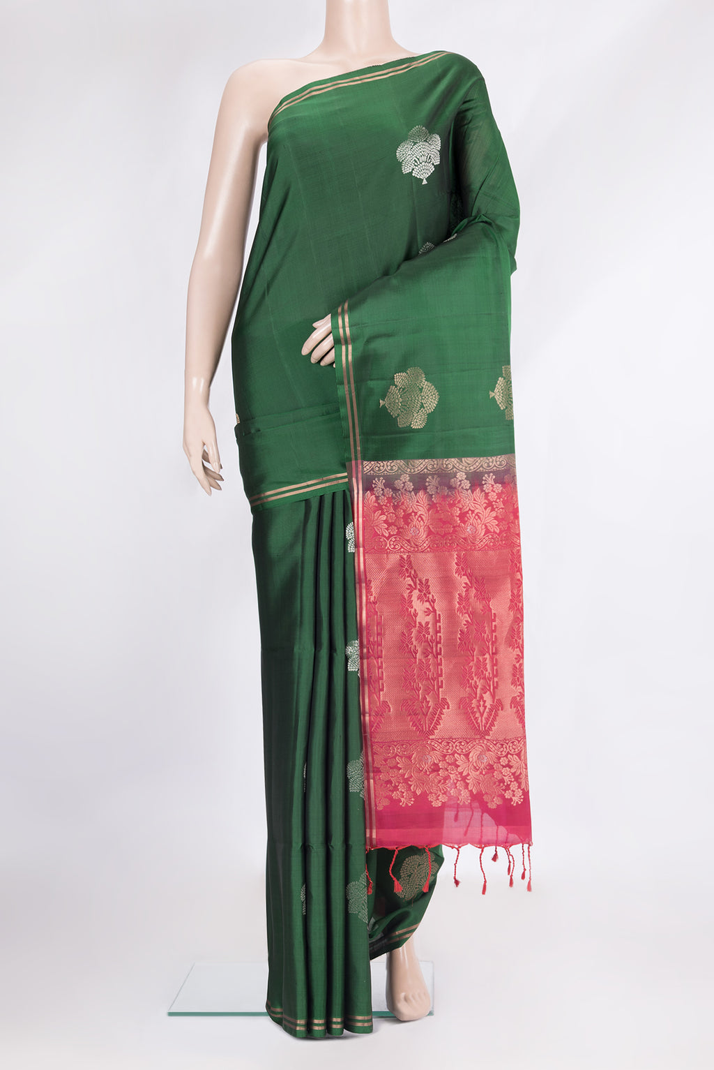 Pure Silk Bottle Green Soft Saree with Zari Butta on the body and Zari Border.  displayed on a mannequin