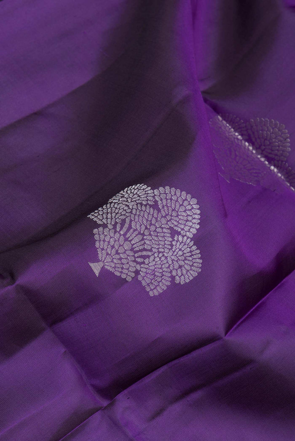 Close up of Purple Soft Silk Saree with Zari Butta on the body and Zari Border.  displaying folds