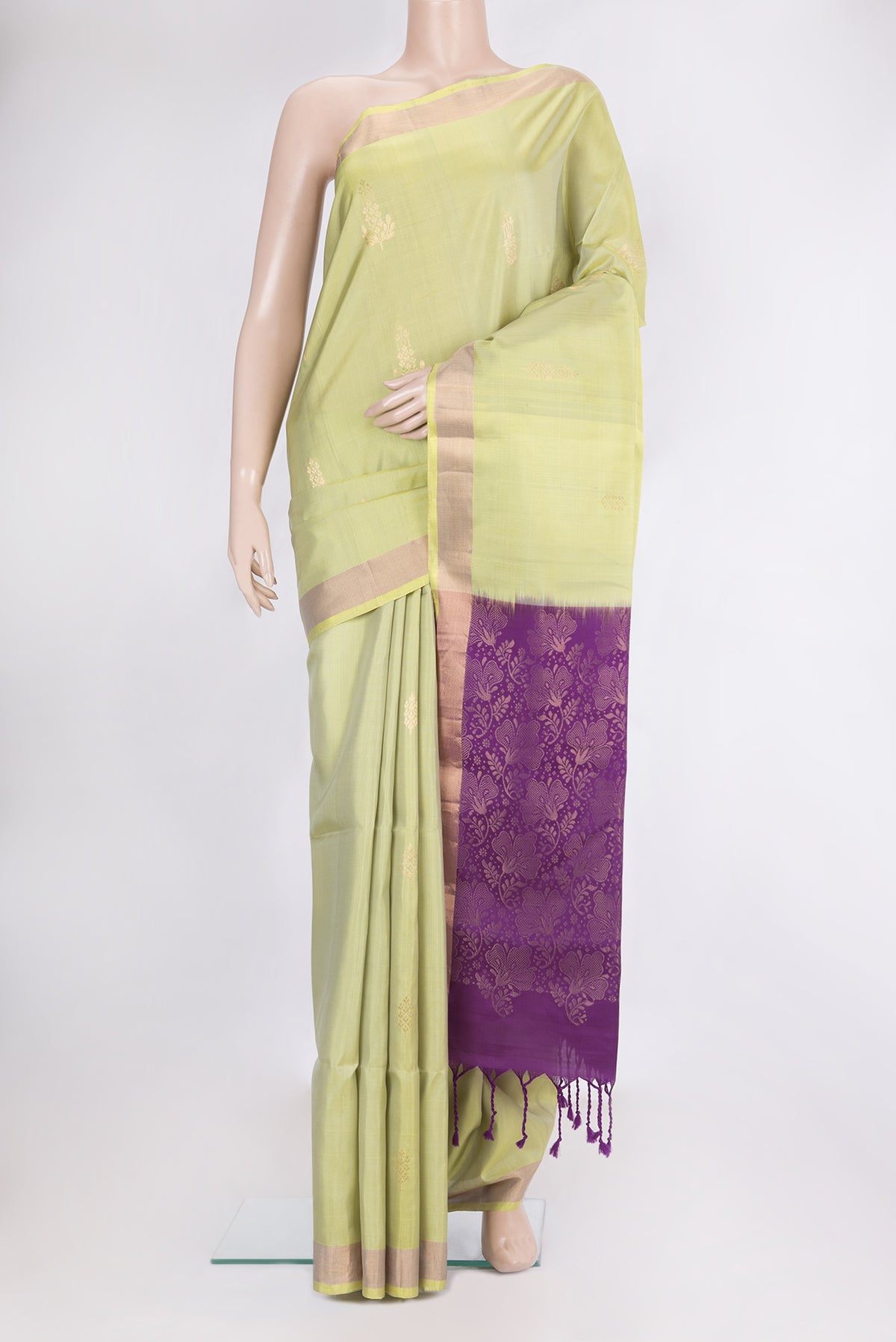 Pure Silk Pista Green Soft Saree with Zari Butta on the body and Zari Border.  displayed on a mannequin