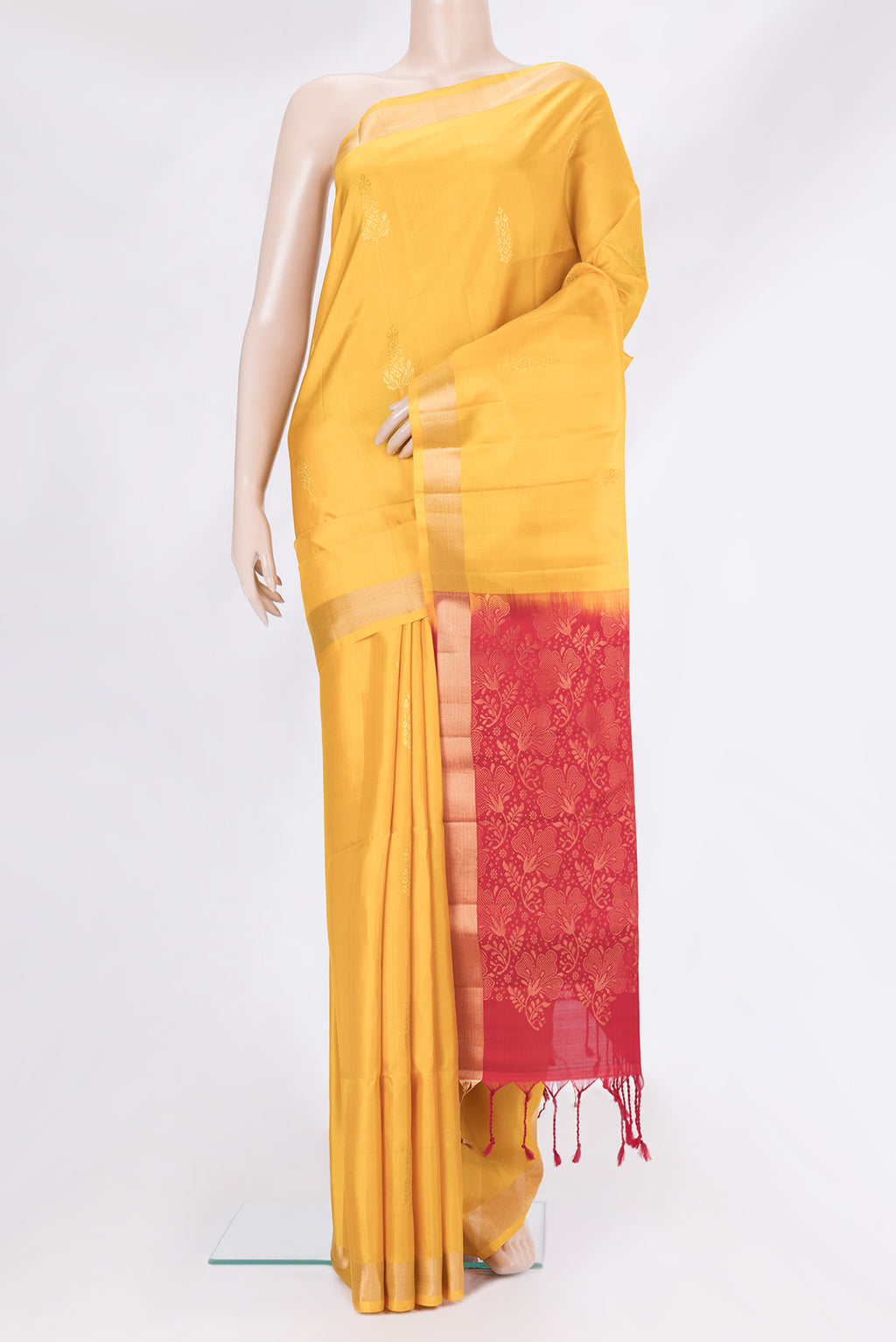 Yellow Soft Silk Saree with Zari Butta on the body and Zari Border.  displayed on a mannequin