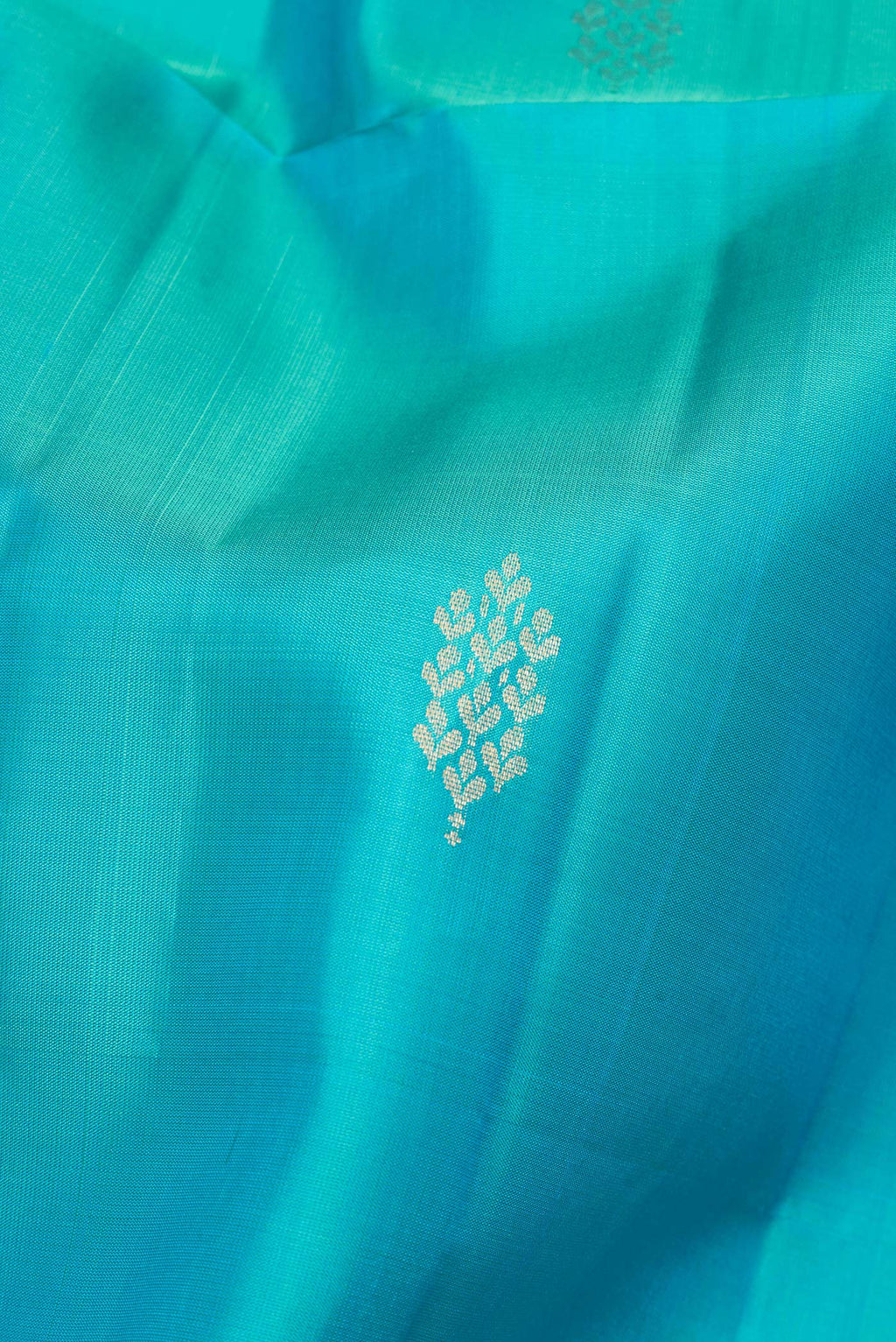 Close up of Pure Silk Sky Blue Soft Saree with Zari Butta on the body and Zari Border.  displaying folds