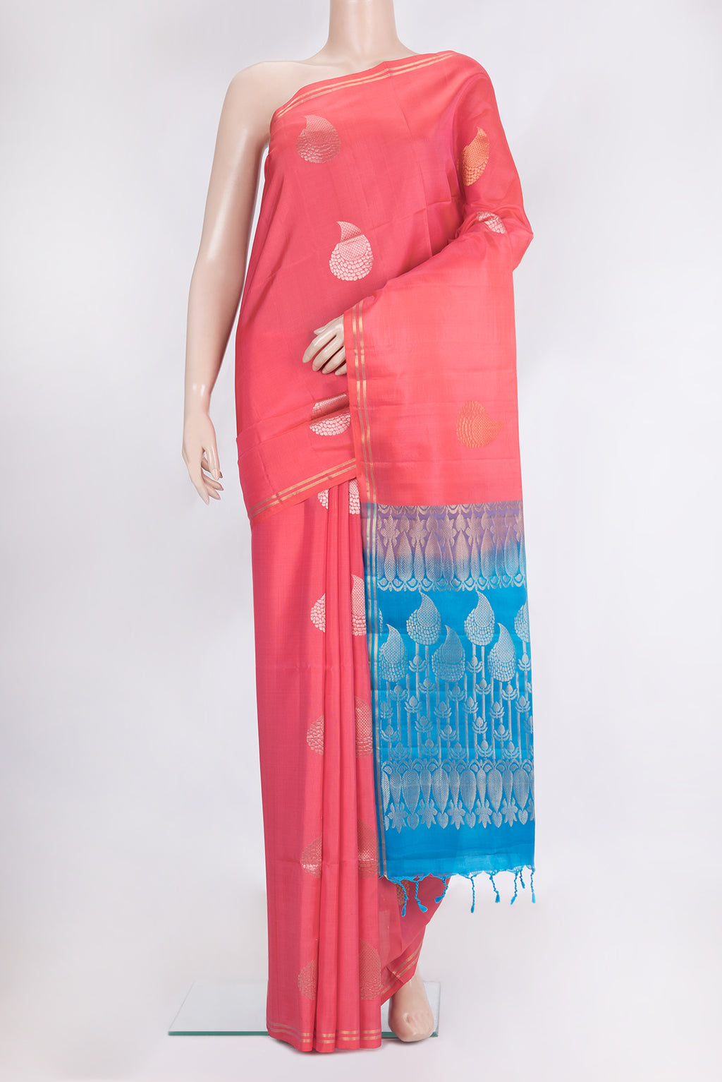 Pure Silk Coral Soft Saree with Zari Butta on the body and Zari Border.  displayed on a mannequin