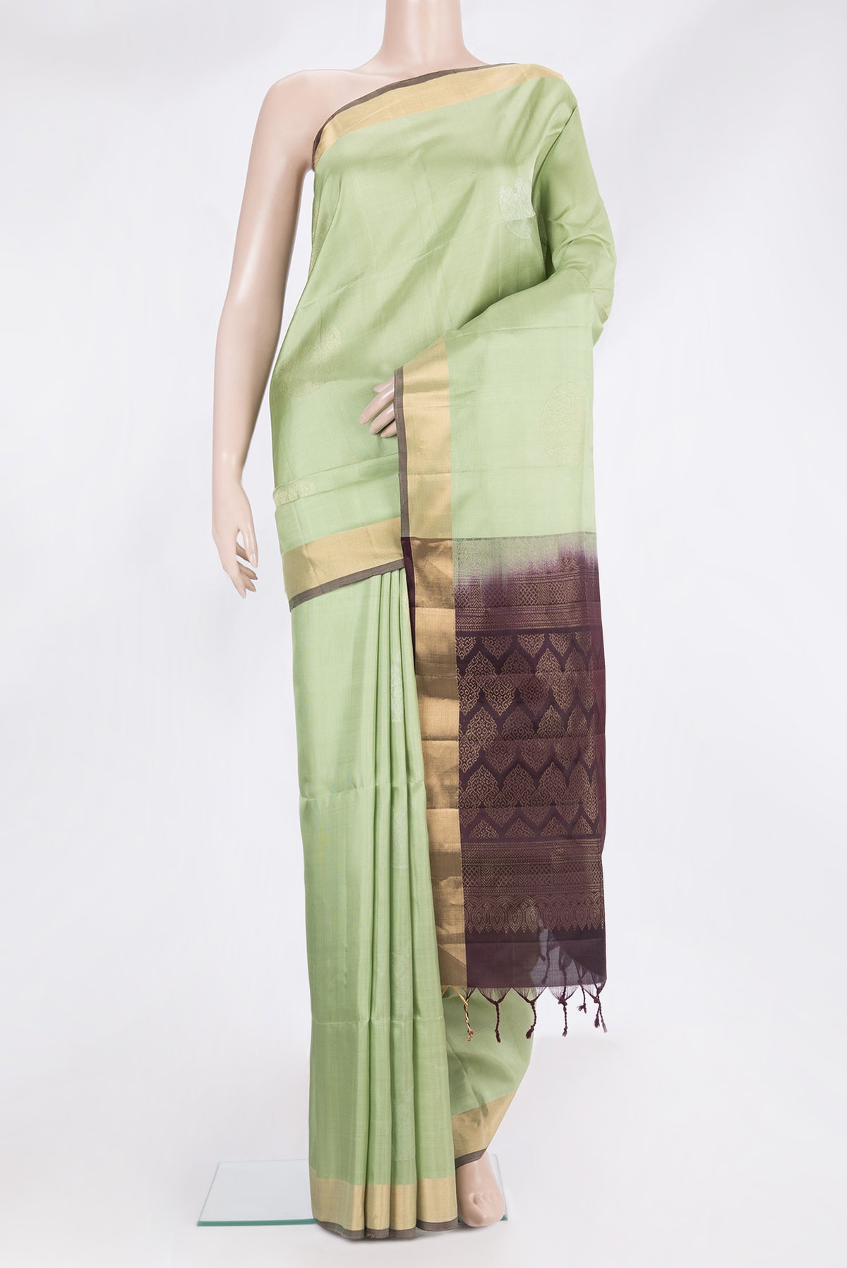 Pure Silk Pista Green Soft Saree with Zari Butta on the body and Zari Border.  displayed on a mannequin