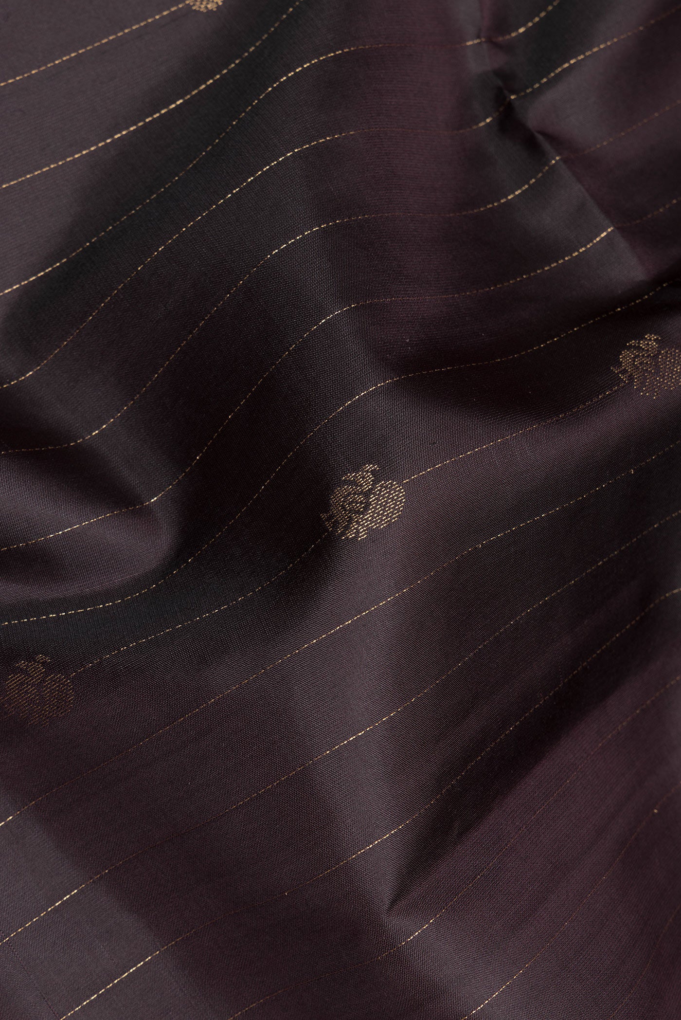 Close up of Pure Silk Brown Soft Saree with Stripes on the body and Zari Border.  displaying folds