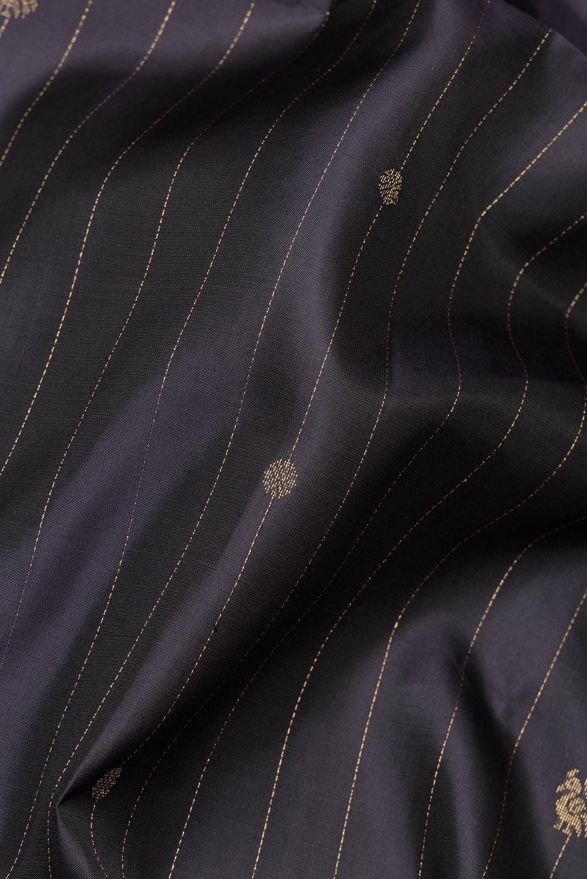 Close up of Pure Silk Black Soft Saree with Stripes on the body and Zari Border.  displaying folds