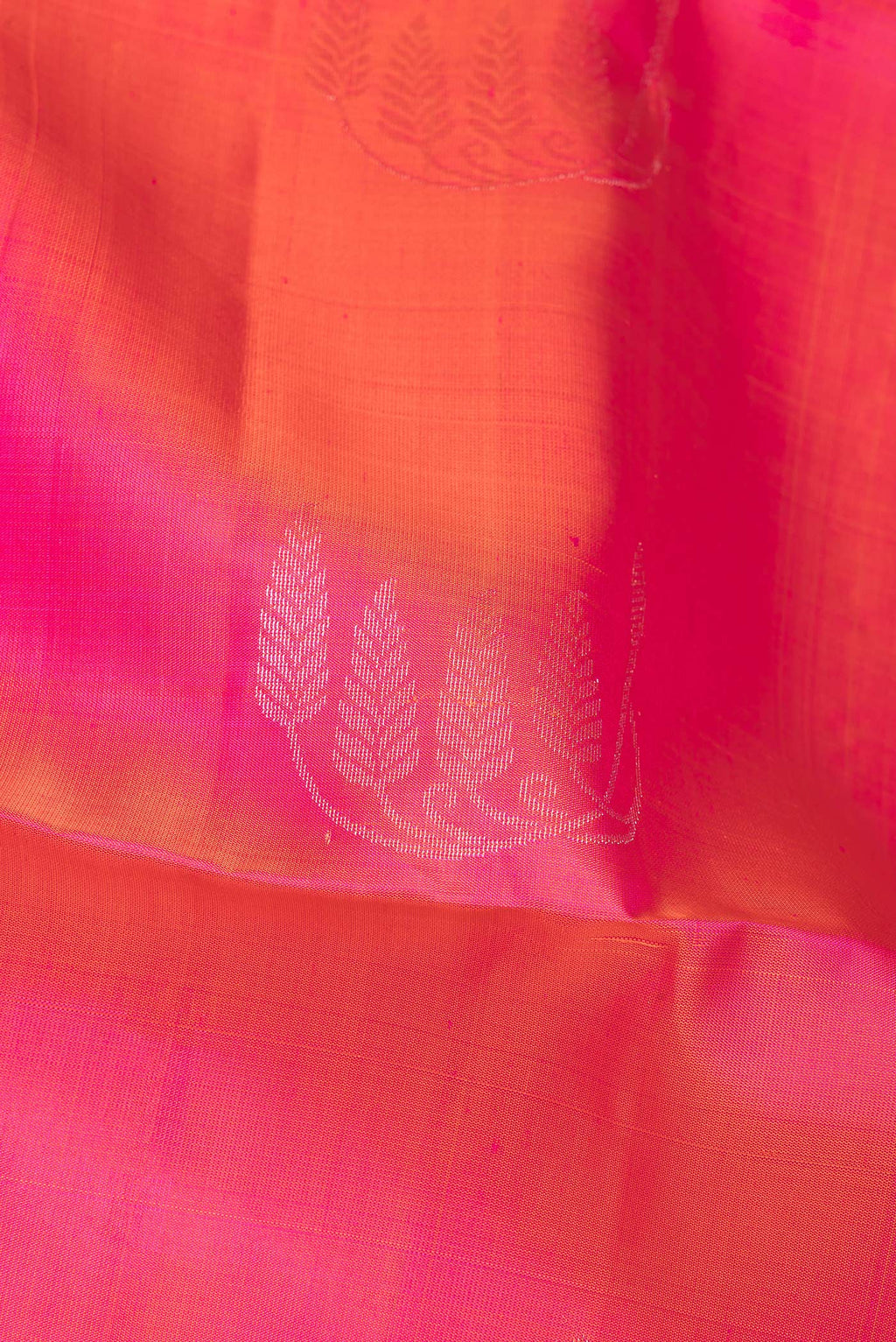 Close up of Pure Silk Pink Soft Saree with Zari Butta on the body and Zari Border.  displaying folds