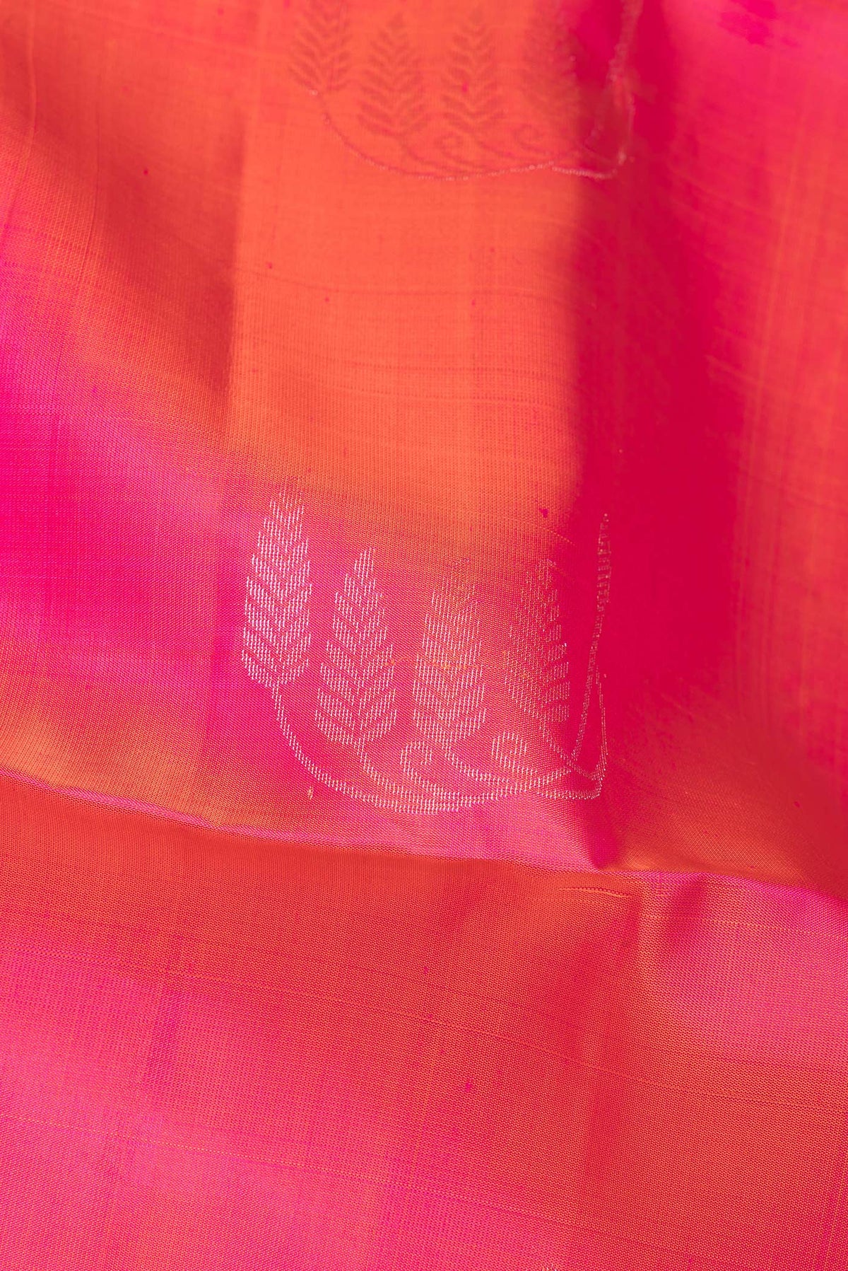 Close up of Pure Silk Pink Soft Saree with Zari Butta on the body and Zari Border.  displaying folds
