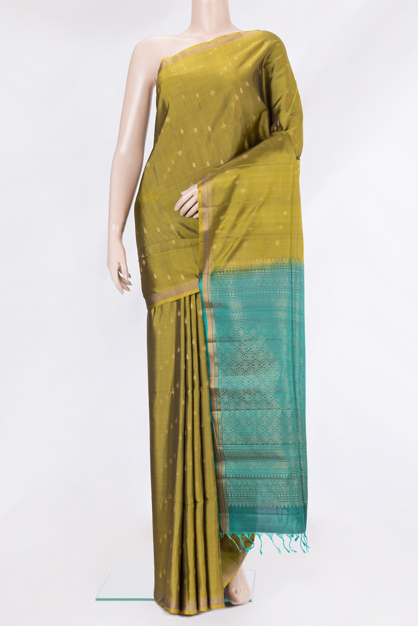 Mehandi Green Soft Silk Saree with Zari Butta on the body and Zari Border.  displayed on a mannequin