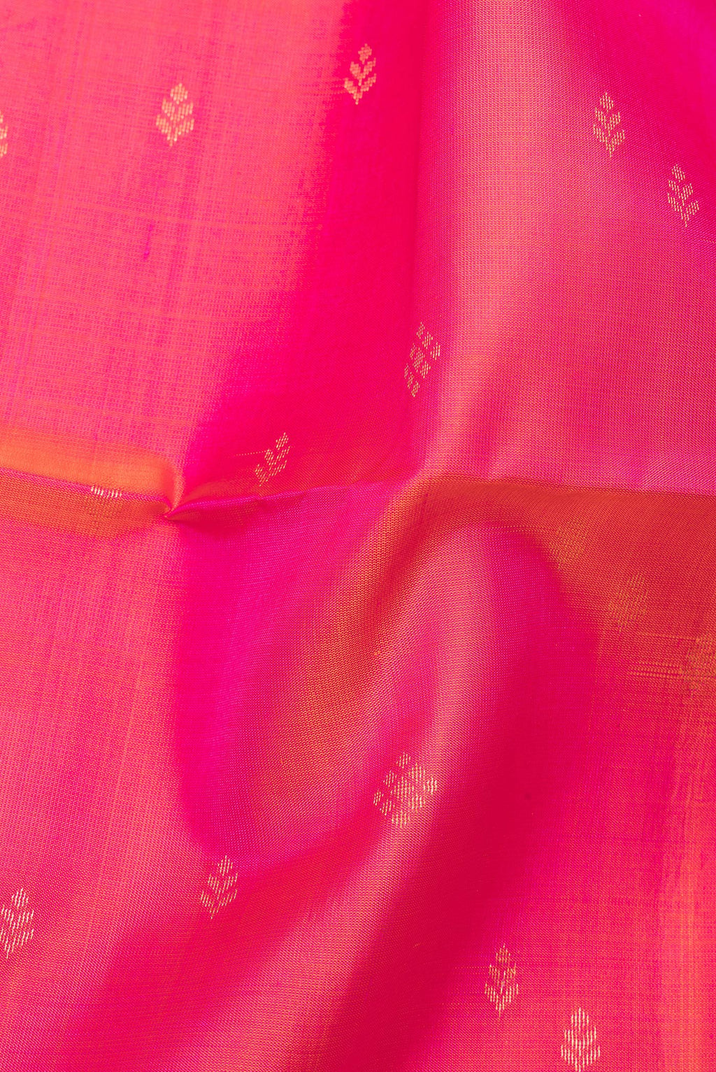 Close up of Pure Silk Pink Soft Saree with Zari Butta on the body and Zari Border.  displaying folds