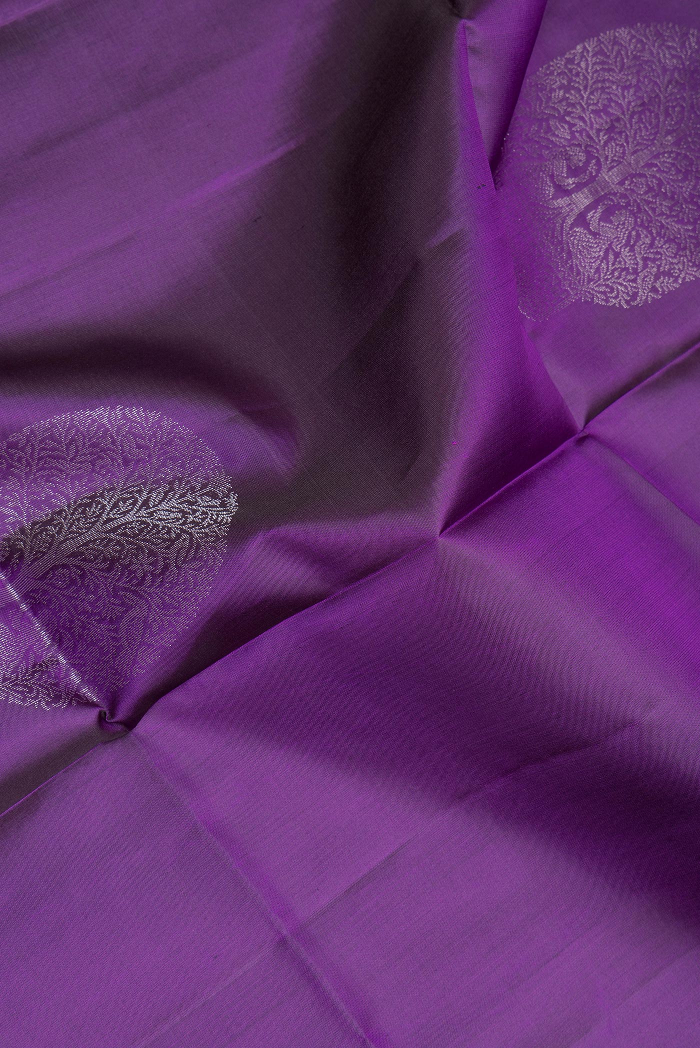 Close up of Pure Silk Purple Soft Saree with Zari Butta on the body and Zari Border.  displaying folds