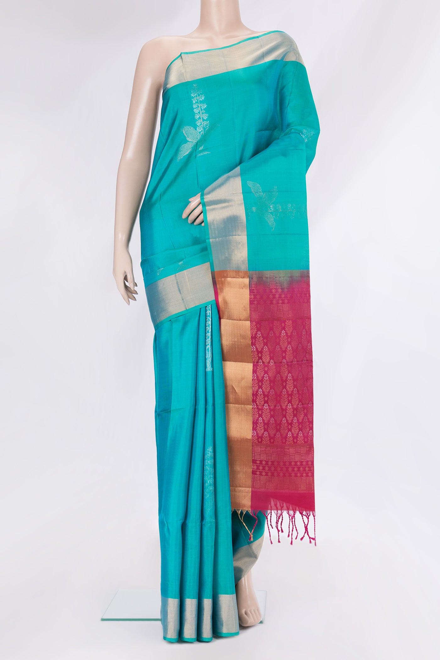 Sky Blue Soft Silk Saree with Zari Butta on the body and Zari Border.  displayed on a mannequin