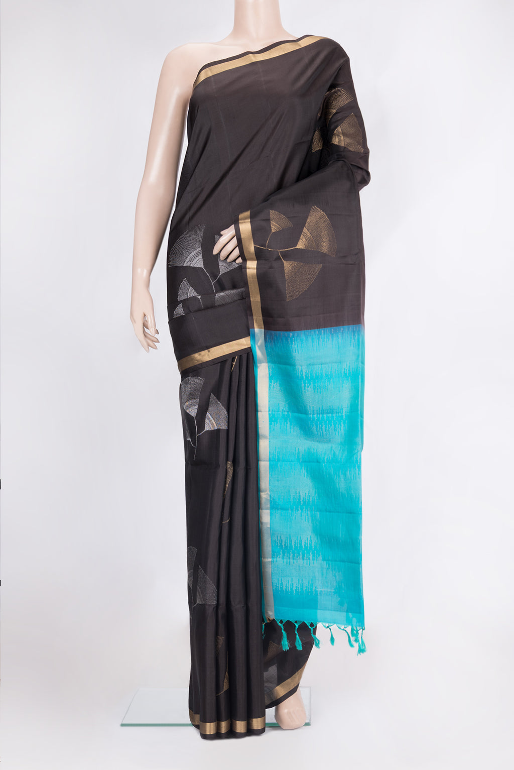 Pure Silk Black Soft Saree with Zari Butta on the body and Zari Border.  displayed on a mannequin