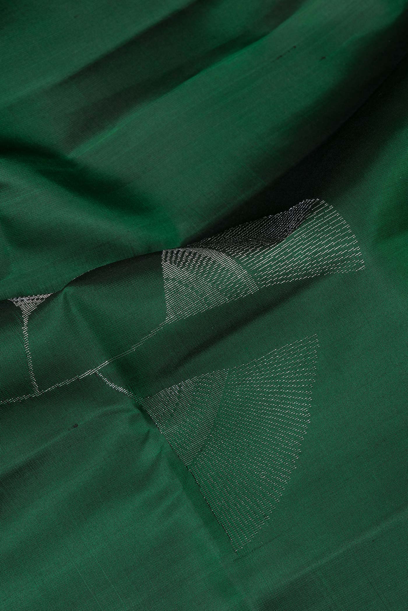 Close up of Pure Silk Bottle Green Soft Saree with Zari Butta on the body and Zari Border.  displaying folds