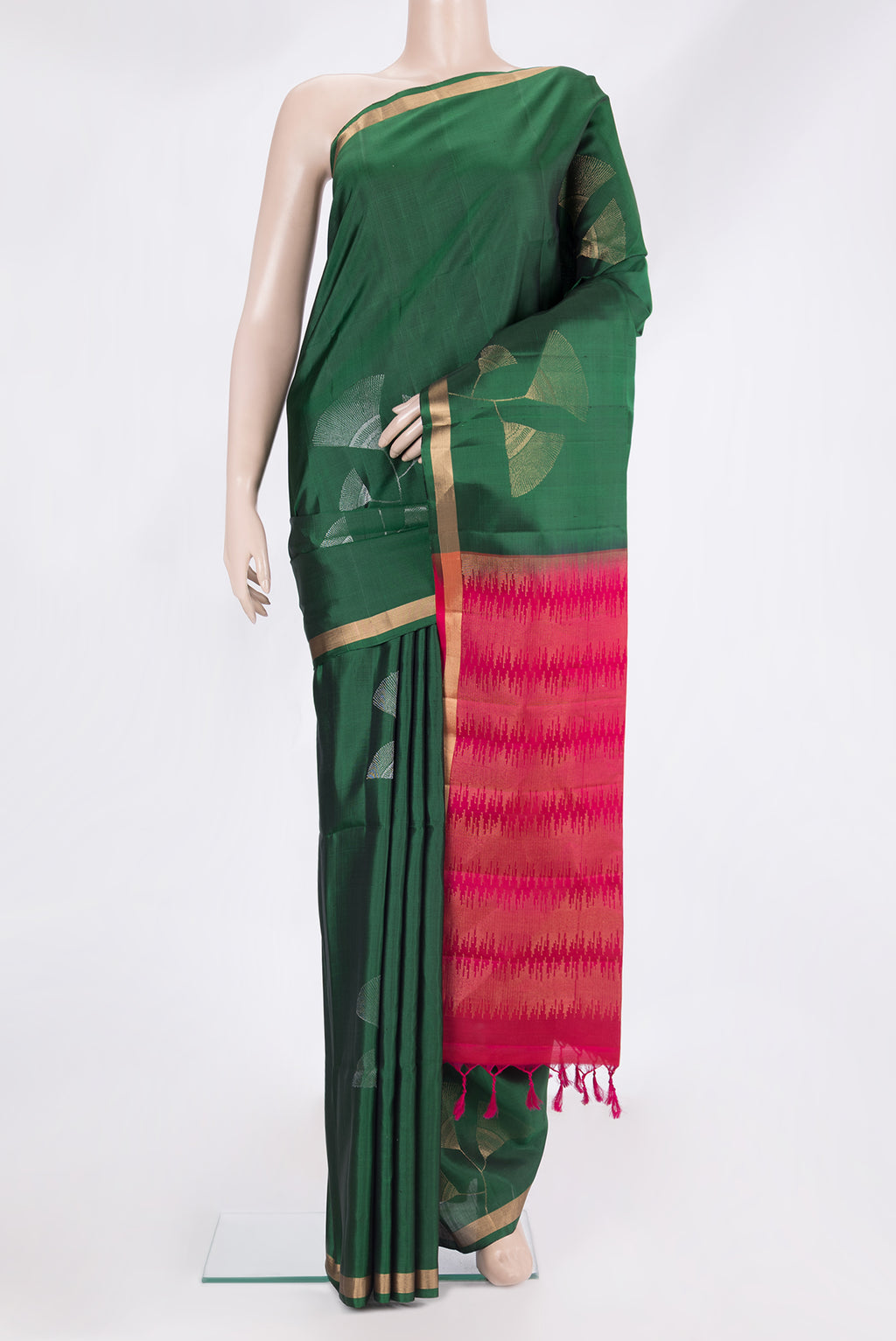 Pure Silk Bottle Green Soft Saree with Zari Butta on the body and Zari Border.  displayed on a mannequin