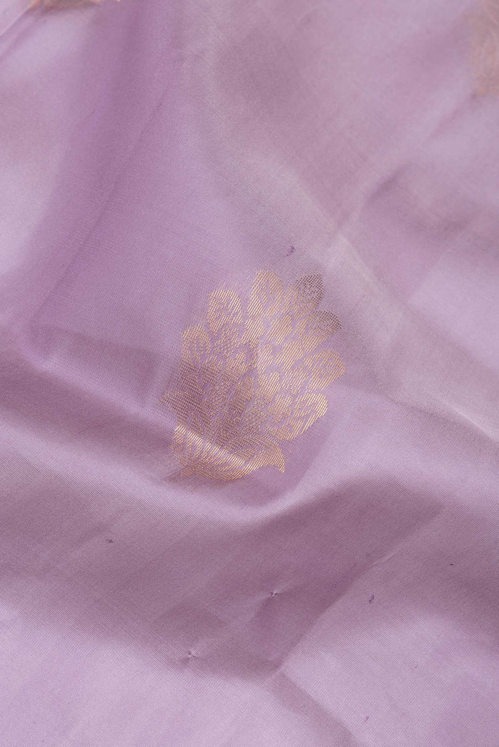 Close up of Lavender Soft Silk Saree with Zari Butta on the body and Zari Border.  displaying folds