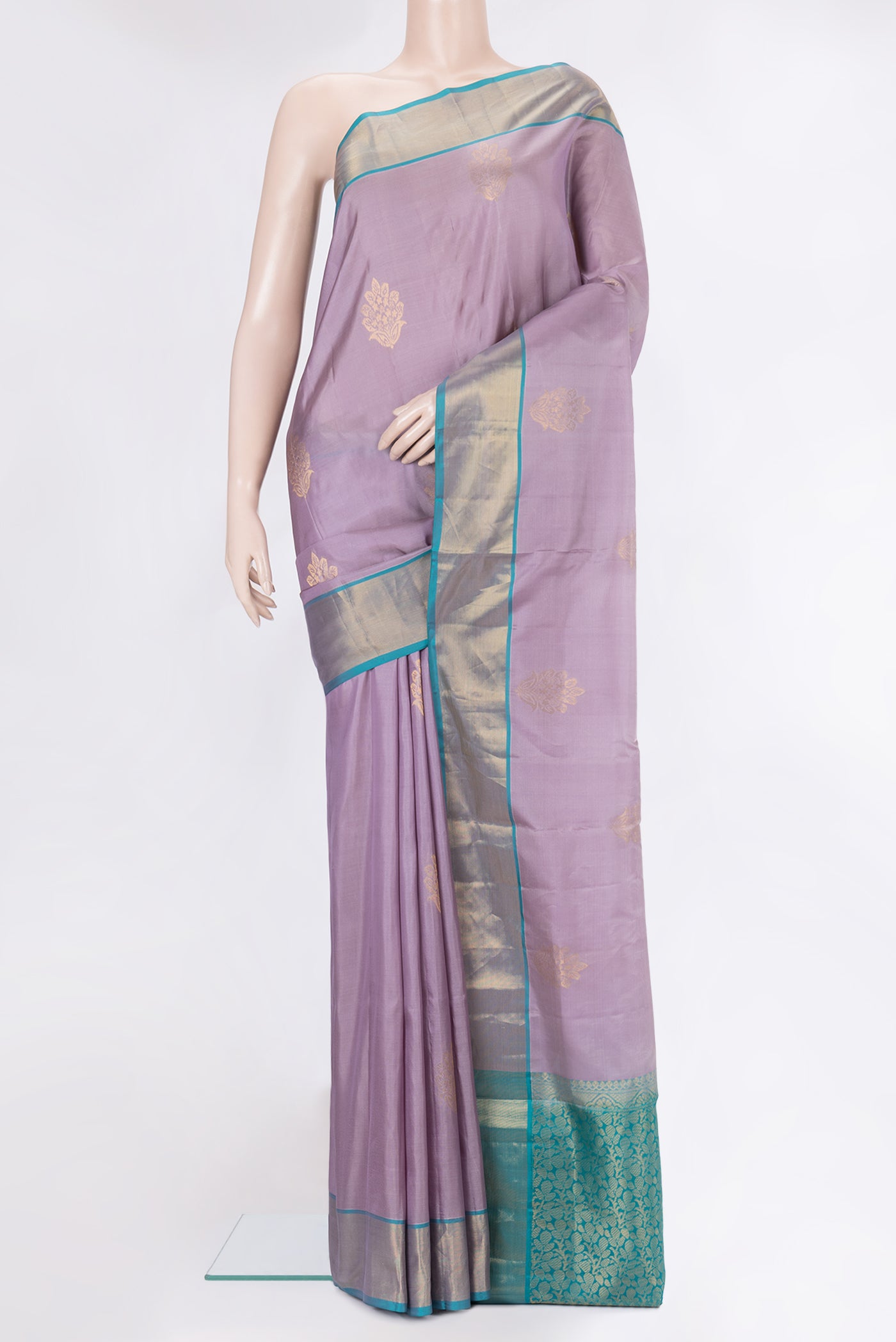 Lavender Soft Silk Saree with Zari Butta on the body and Zari Border.  displayed on a mannequin