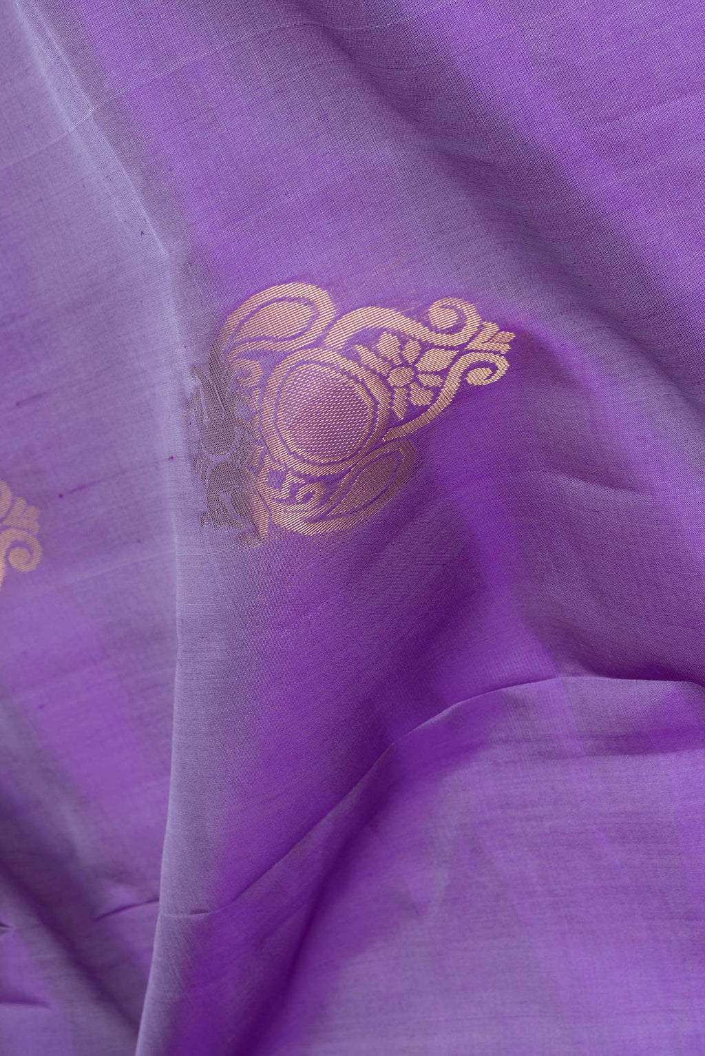 Close up of Lavender Soft Silk Saree with Zari Butta on the body and Zari Border.  displaying folds