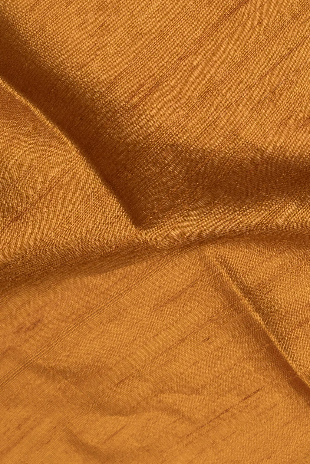 Close up of Pure Silk Mustard Raw Saree with Plain Body and Zari Border.  displaying folds