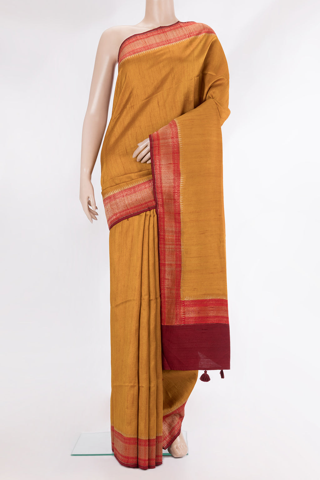 Pure Silk Mustard Raw Saree with Plain Body and Zari Border.  displayed on a mannequin