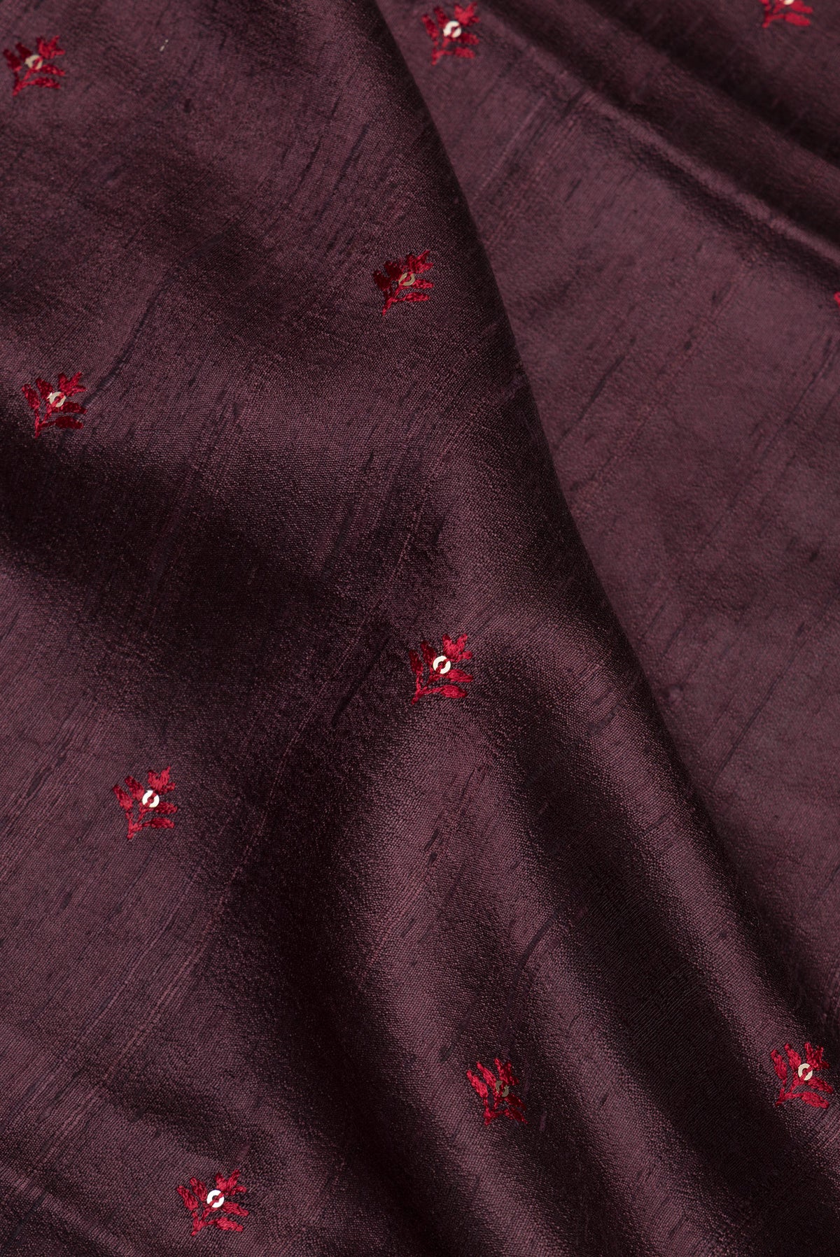 Close up of Pure Silk Brown Raw Saree with Embroidery on the body and Zari Border.  displaying folds