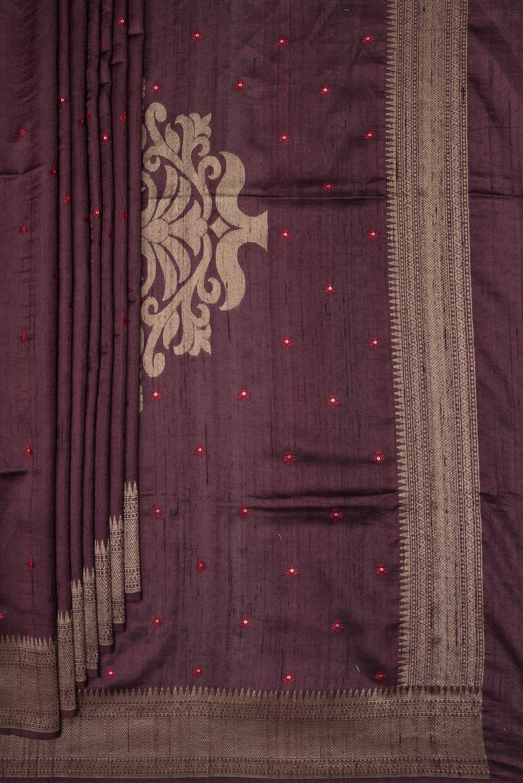 Pleats and pallu of Pure Silk Brown Raw Saree with Embroidery on the body and Zari Border. 