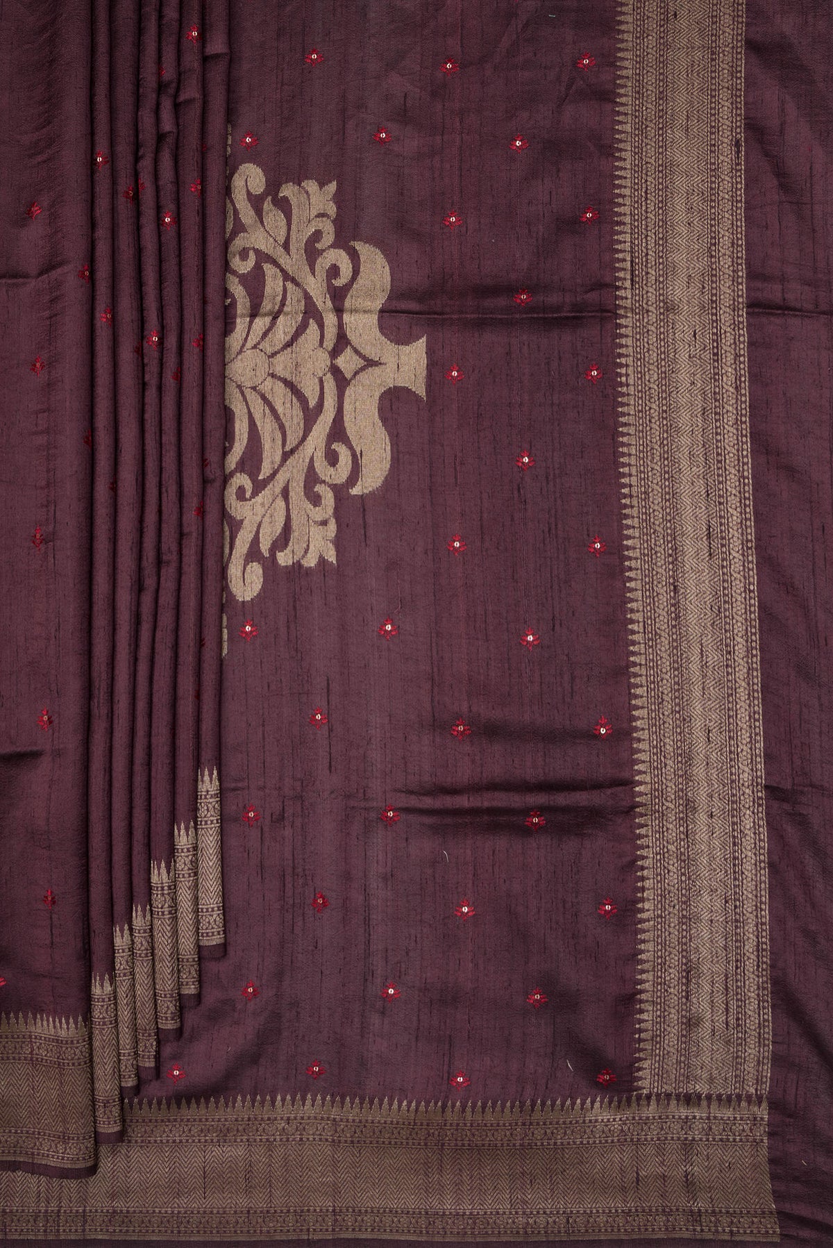 Pleats and pallu of Pure Silk Brown Raw Saree with Embroidery on the body and Zari Border. 