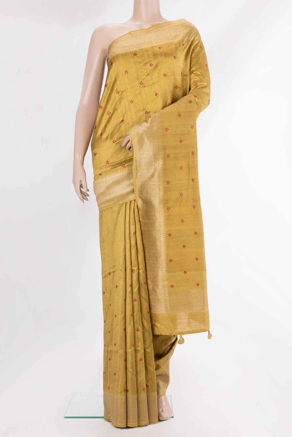 Pure Silk Gold Dual Tone Raw Saree with Embroidery on the body and Zari Border.  displayed on a mannequin