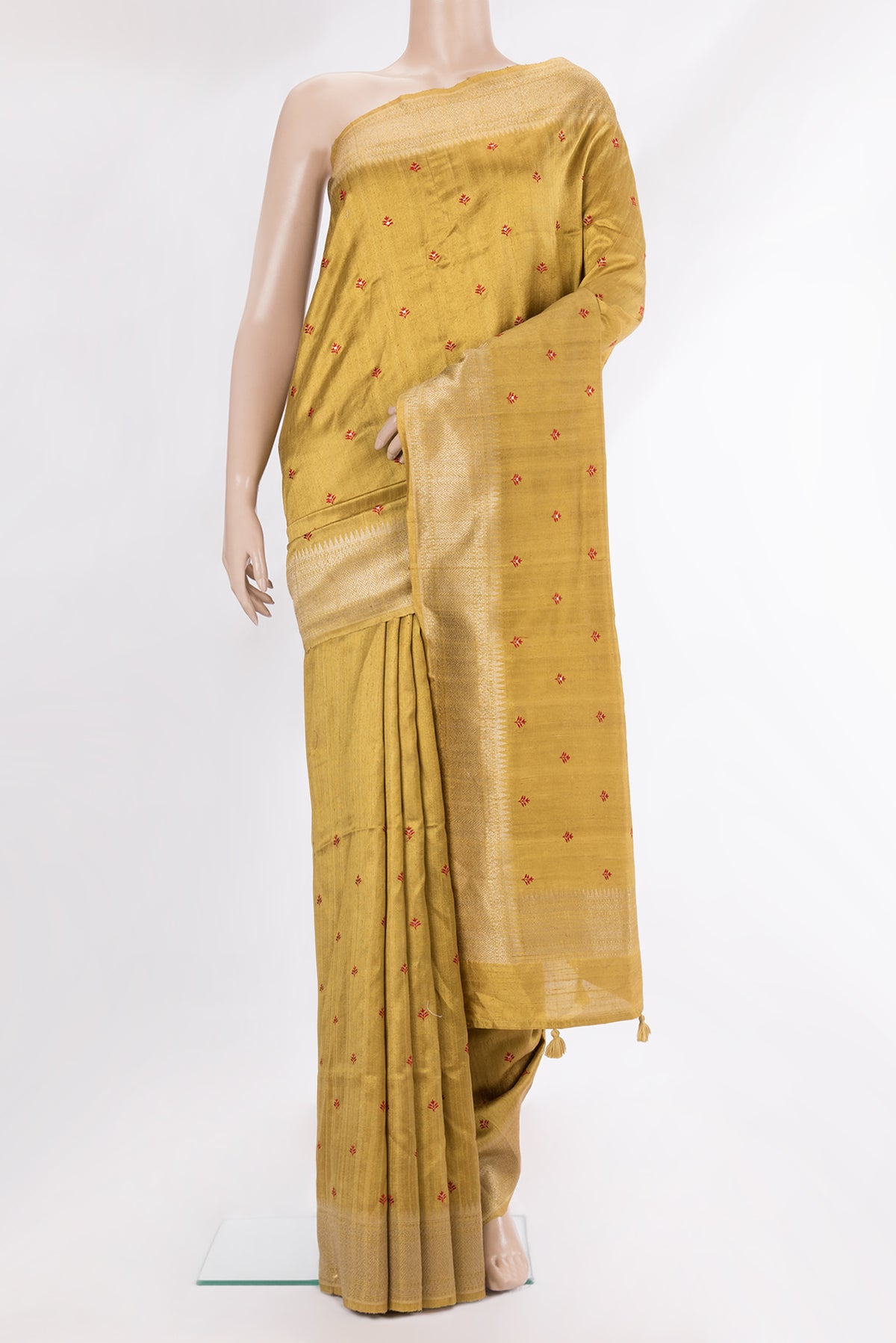 Pure Silk Gold Dual Tone Raw Saree with Embroidery on the body and Zari Border.  displayed on a mannequin