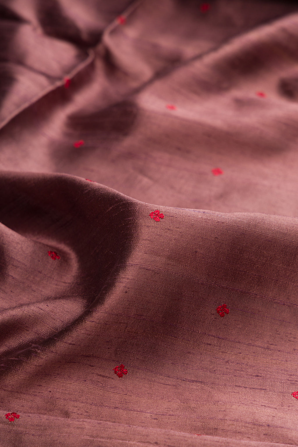 Close up of Brown Tussar Saree with Thread Butta on the body and Fancy Border.  displaying folds